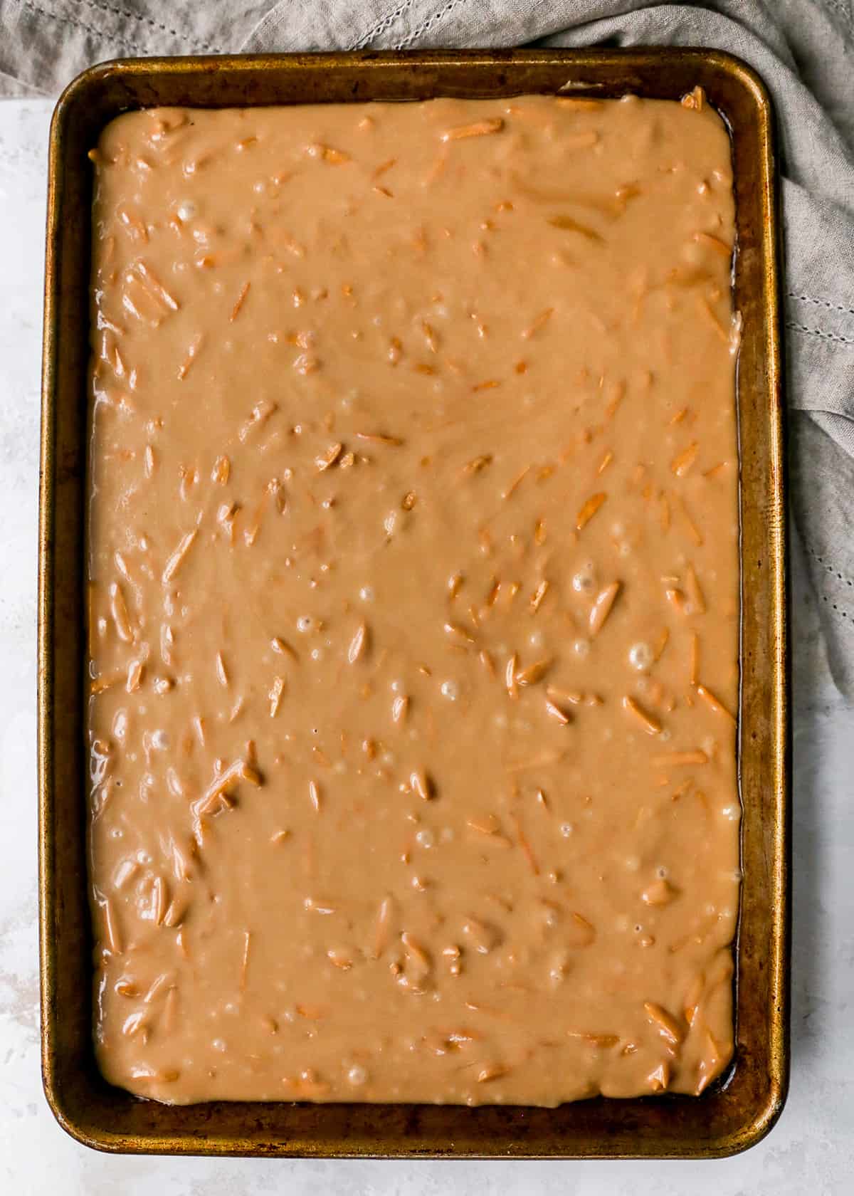 Almond Toffee spread out on a baking sheet