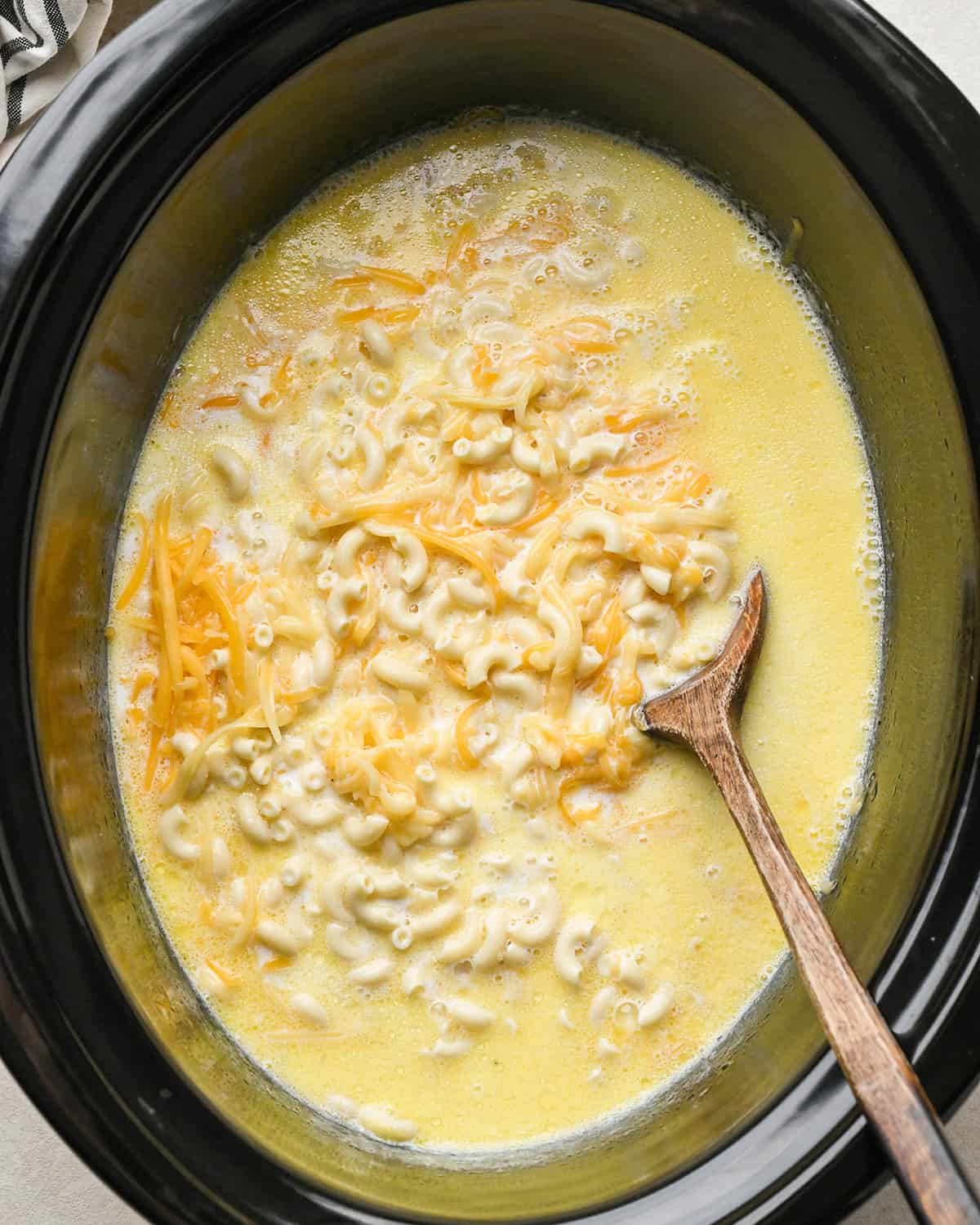 stirring slow cooker mac and cheese