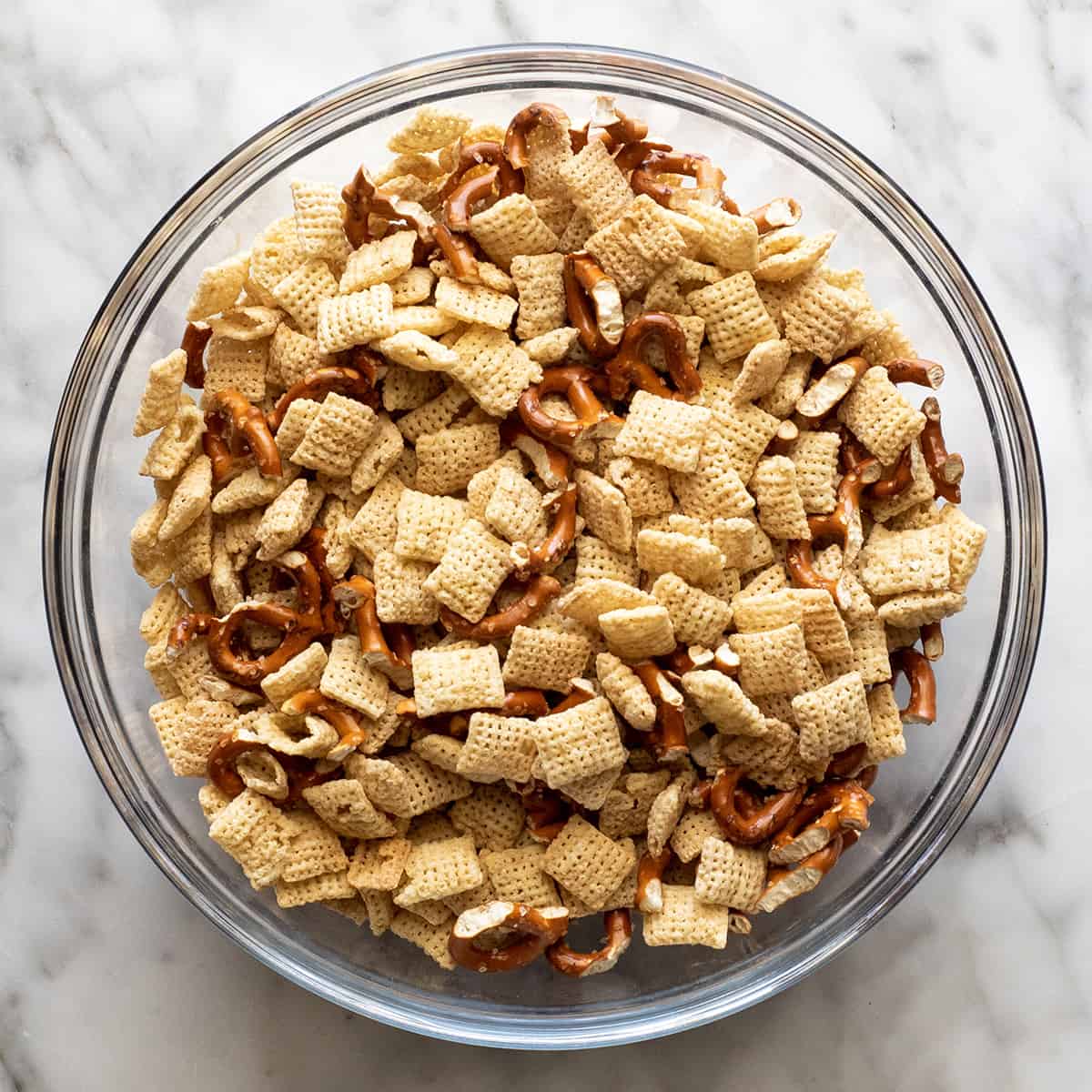 cereal and pretzels in a bowl to make Christmas puppy chow