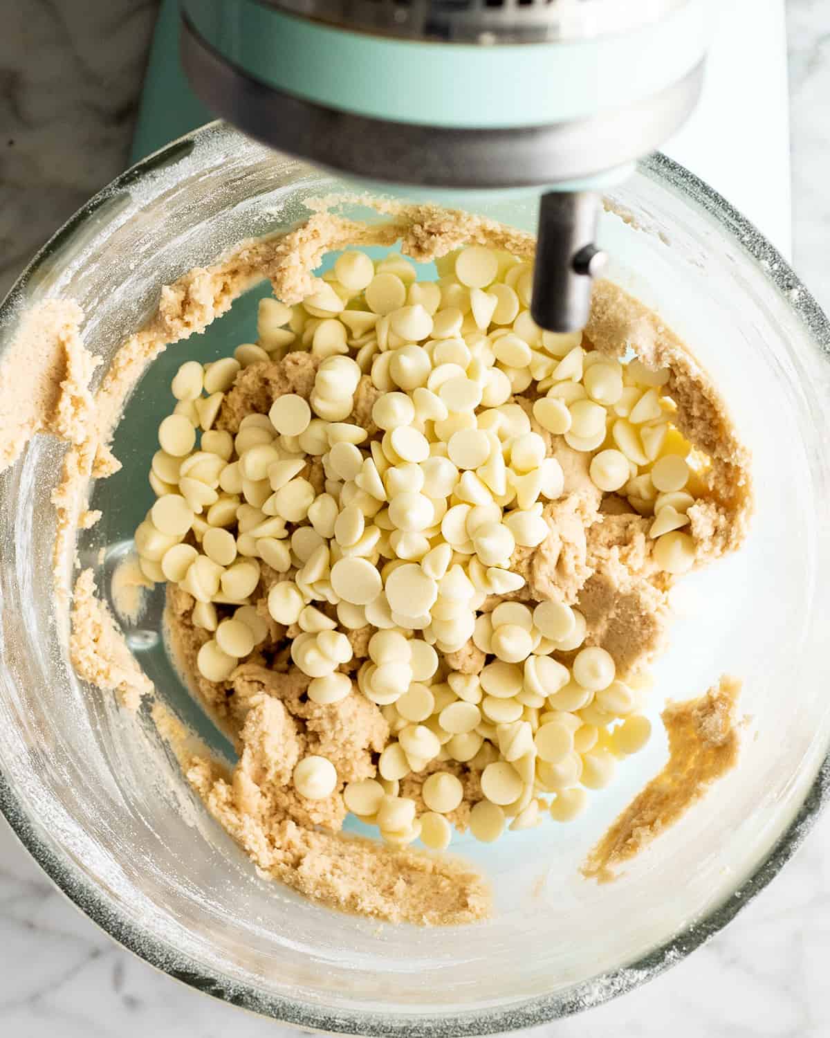 how to make White Chocolate Chip Cookies - adding white chocolate chips to the dough
