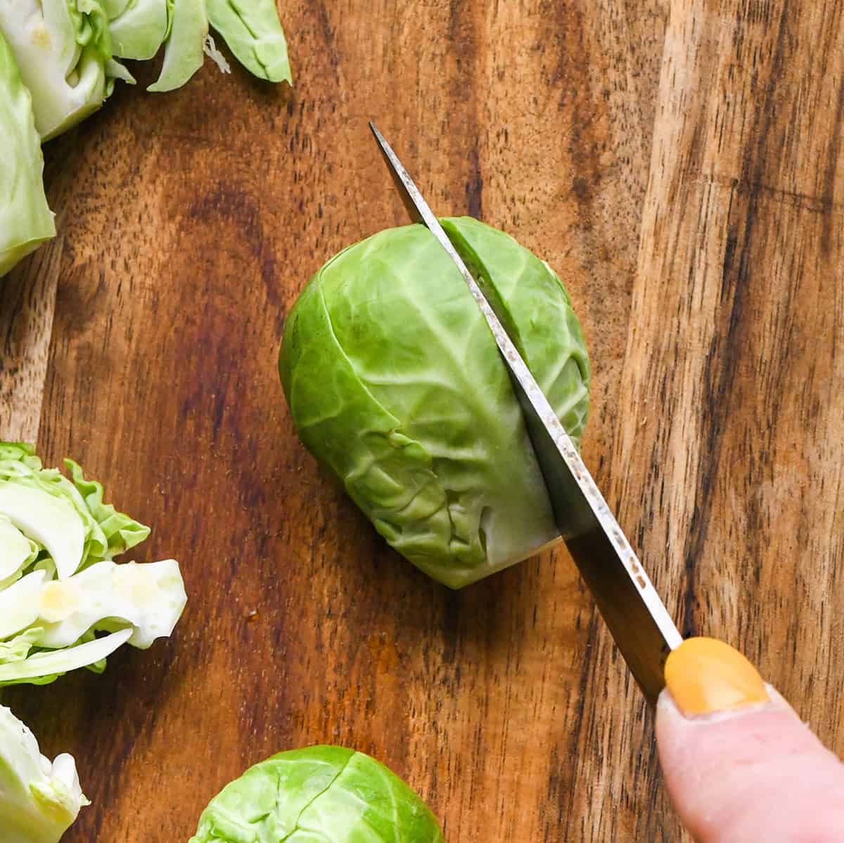 cutting a brussel sprout in half