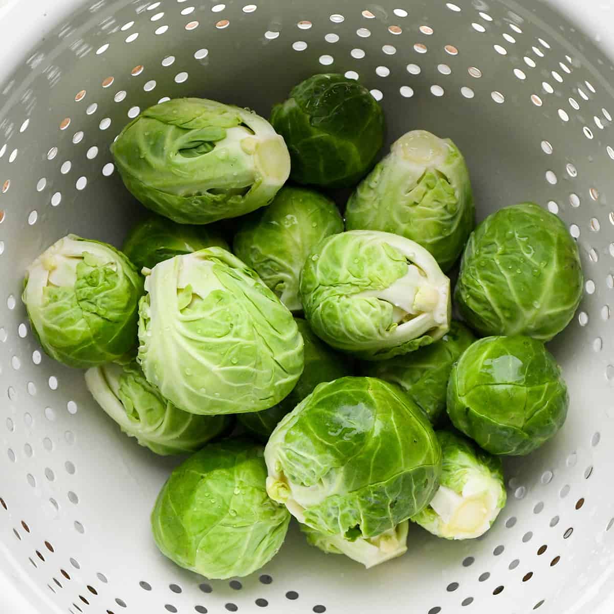 brussels sprouts in a colander to be washed