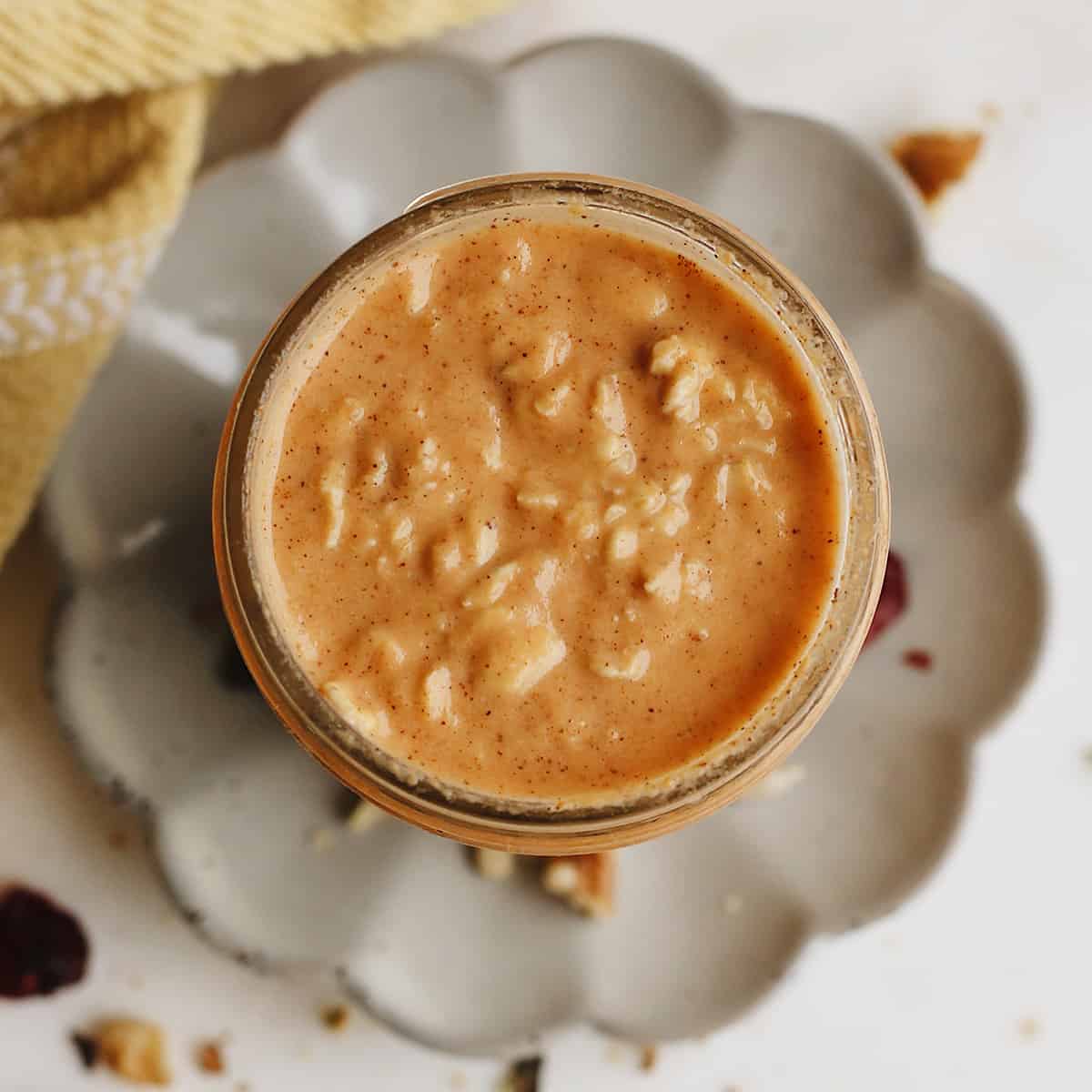 overhead photo of Pumpkin Overnight Oats in a glass jar with no toppings