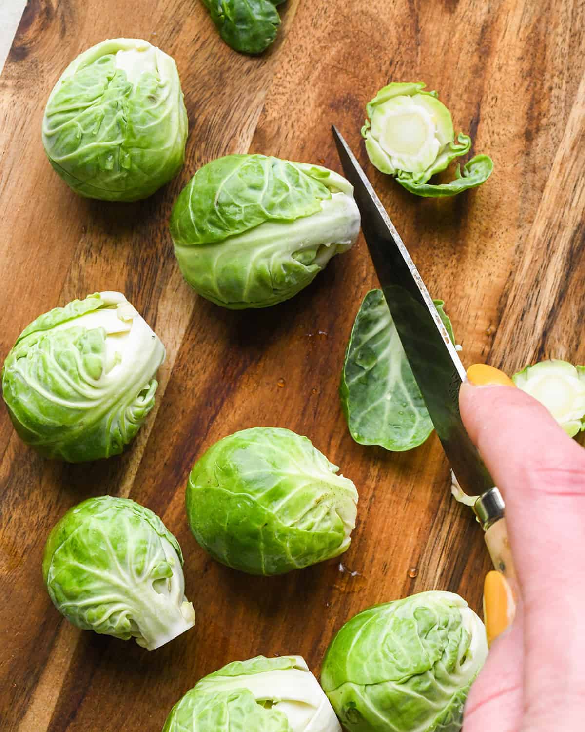 a photo showing how to trim brussels sprouts