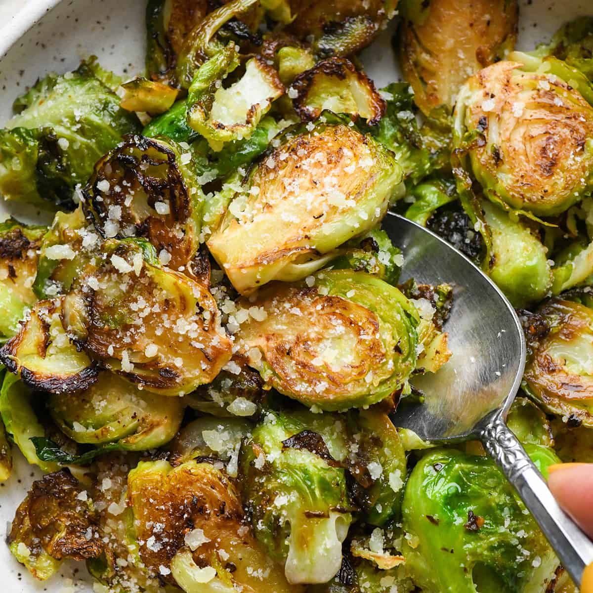 Sautéed Brussels Sprouts in a bowl with a spoon