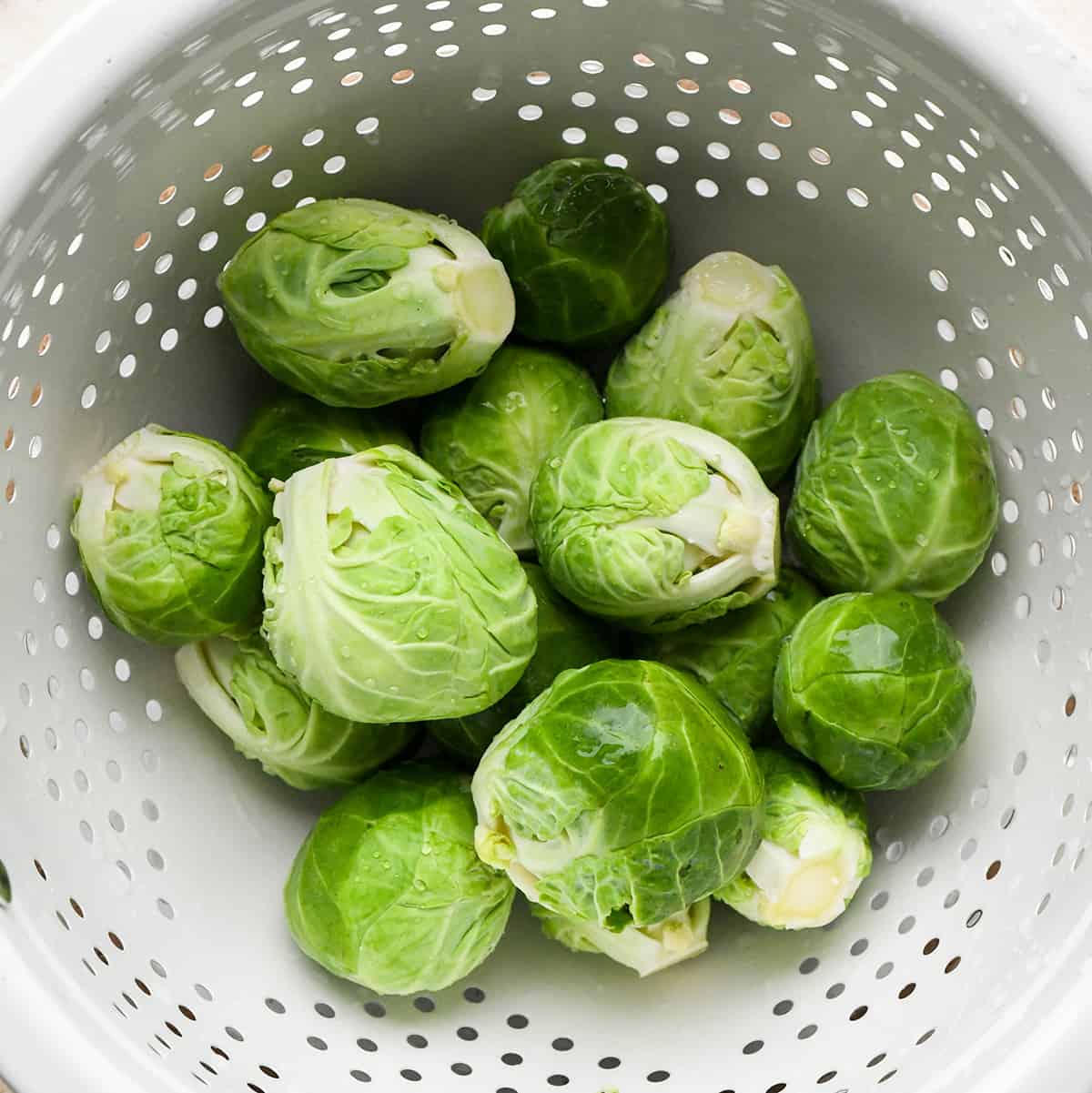 Brussels sprouts in a colander after being washed