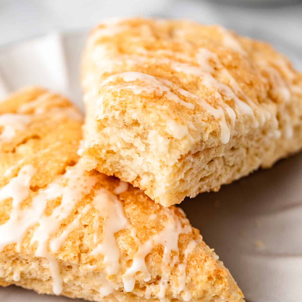 two Buttermilk Scones, one with a bite taken out of it