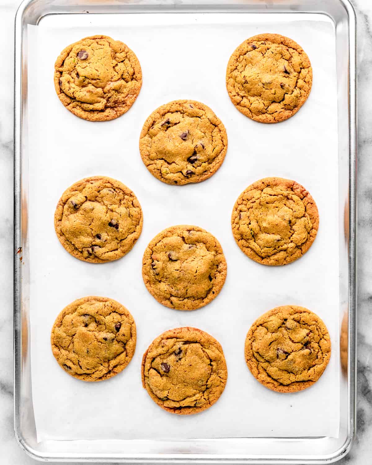 9 Pistachio Cookies on a baking sheet after baking