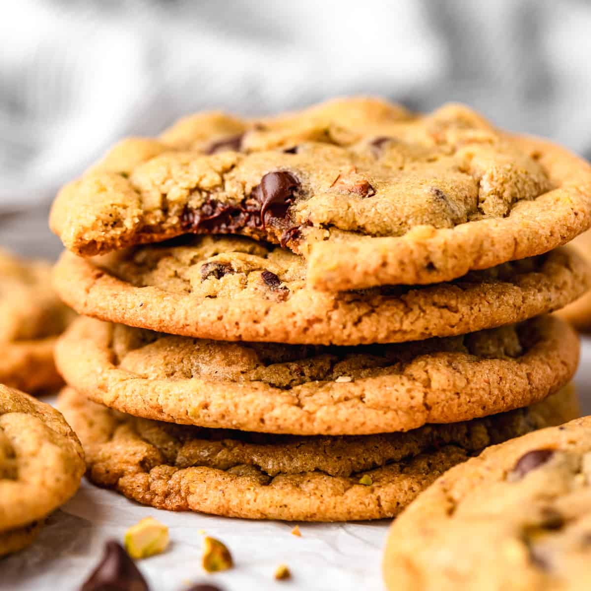 stack of 4 Pistachio Cookies, the top one has a bite taken out of it