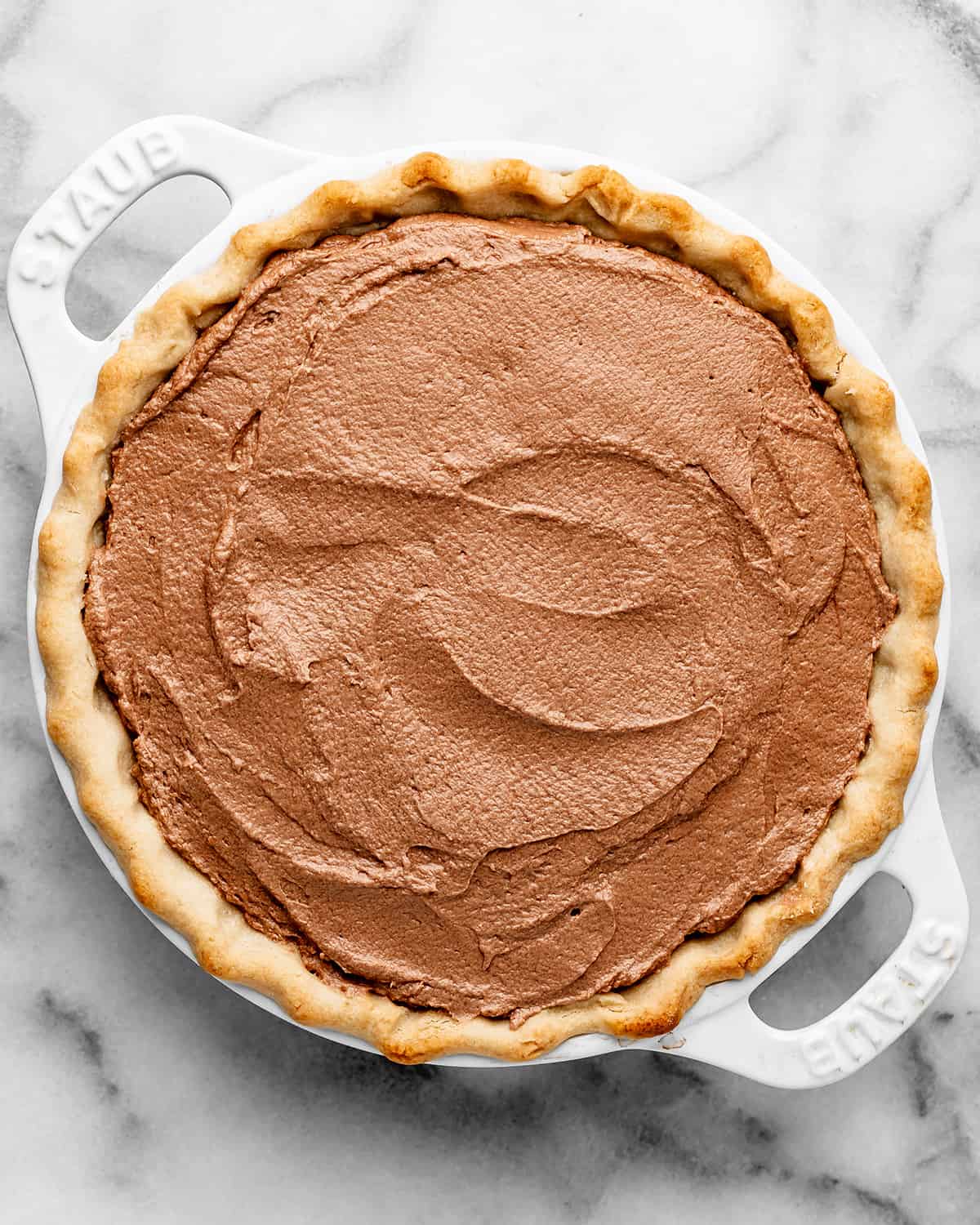 assembling french silk pie - spreading chocolate into pie crust