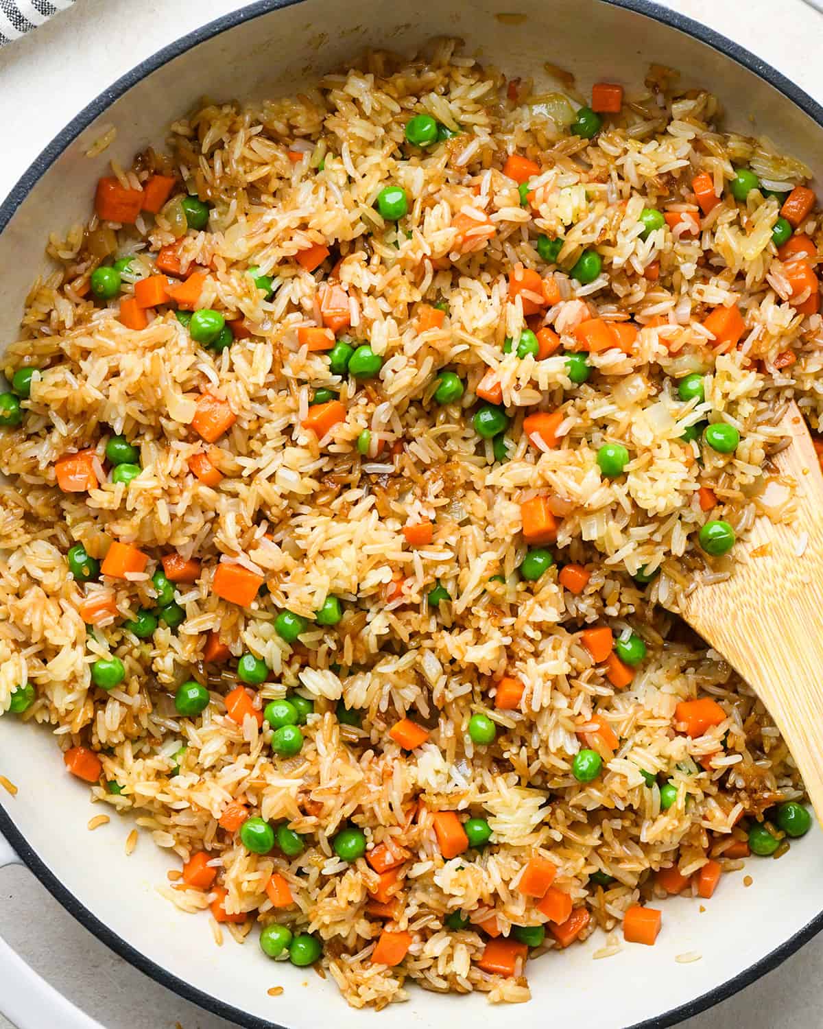 How to Make Fried Rice - adding peas, soy sauce and seasonings after mixing