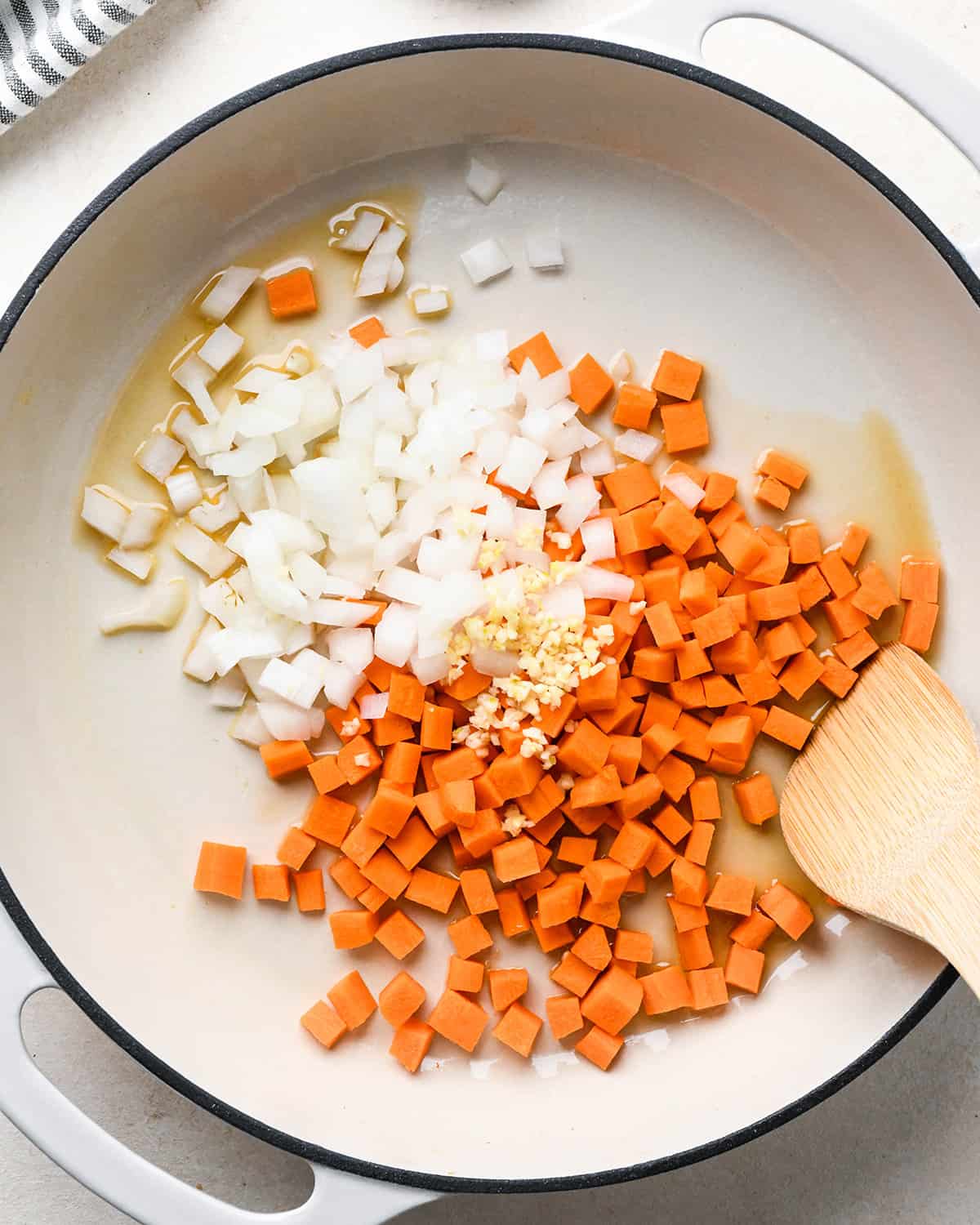 How to Make Fried Rice - carrots, garlic, onion and sesame oil in a pan before cooking