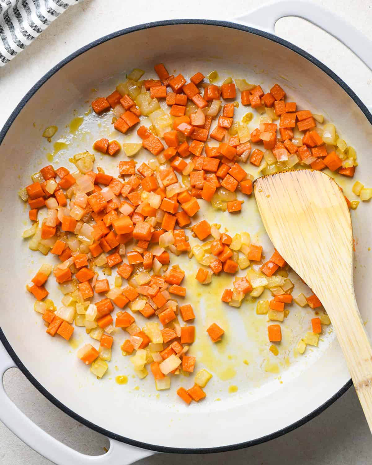 How to Make Fried Rice - carrots, garlic, onion and sesame oil in a pan after cooking