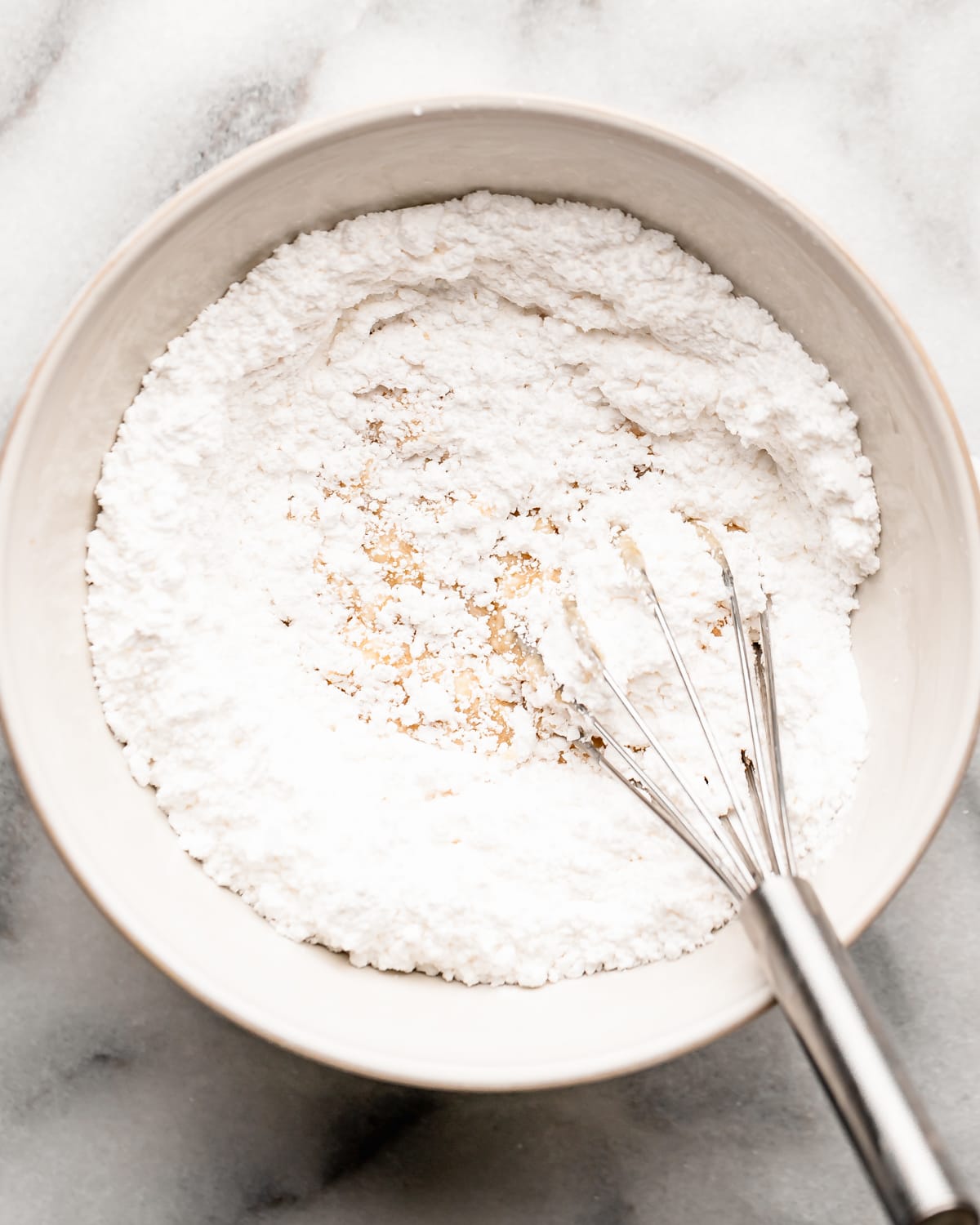 making Maple Glaze in a bowl - whisking in powdered sugar