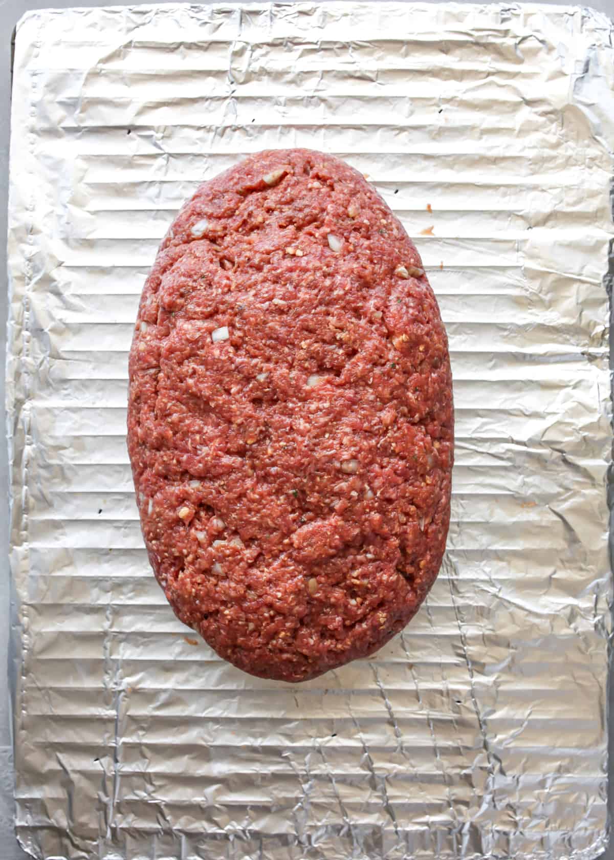 meatloaf formed on a wire rack before baking. 