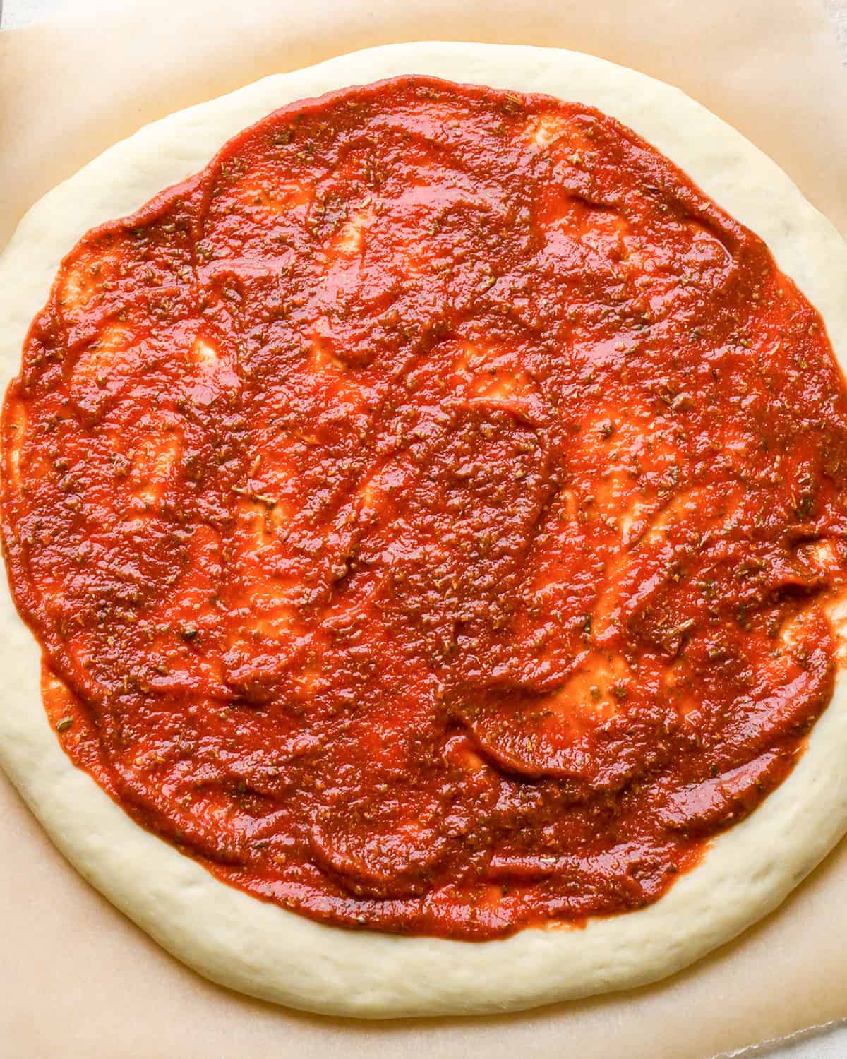 How to Make Pizza - sauce spread evenly on dough