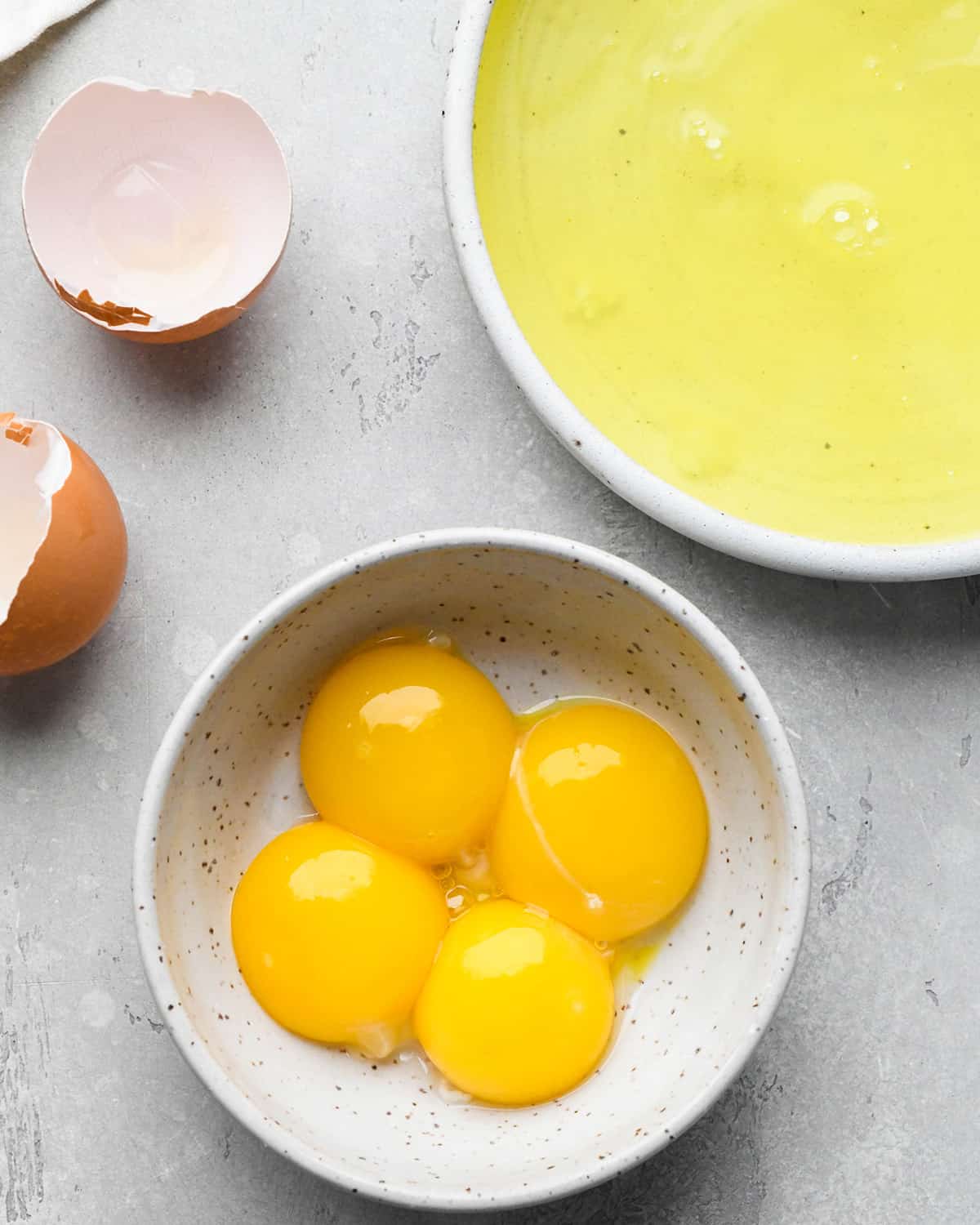 egg yolks and egg whites separated in two separate bowls