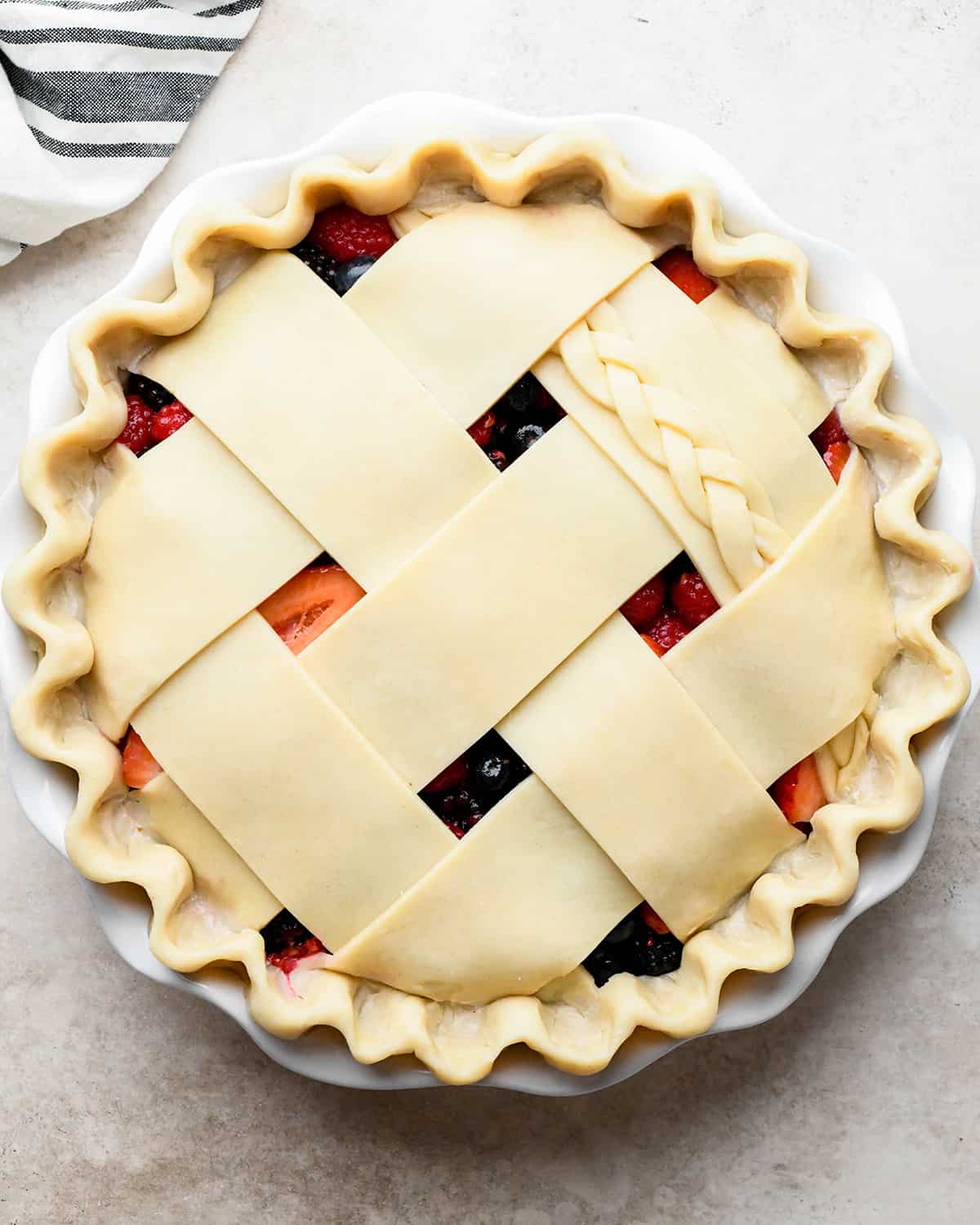 assembling berry pie - lattice top put over filling