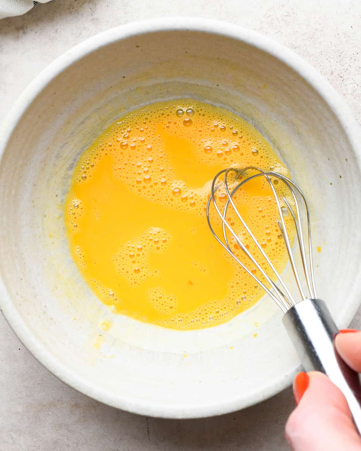 egg wash whisked in a bowl for mixed berry pie