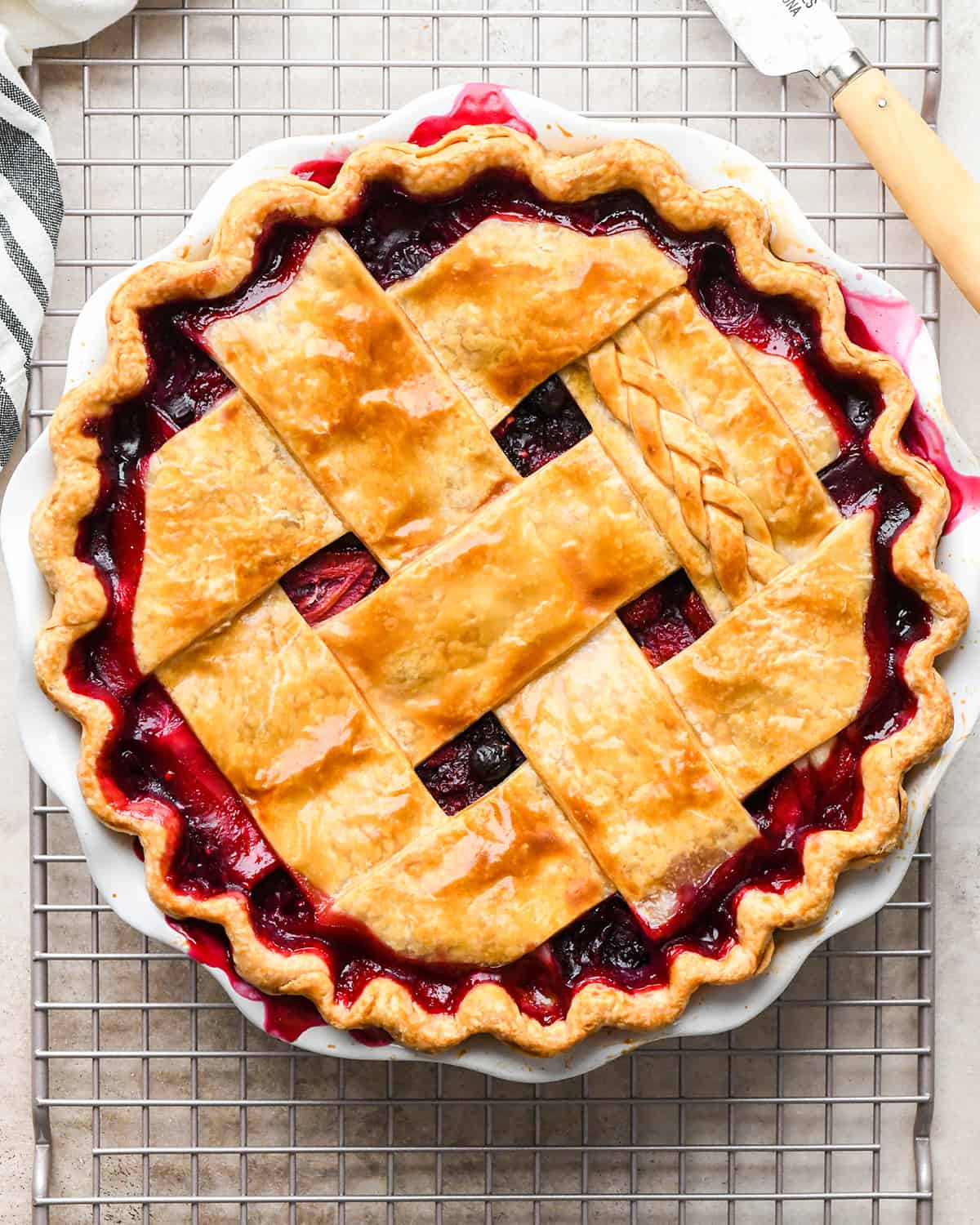 Mixed Berry Pie on a wire cooling rack after baking