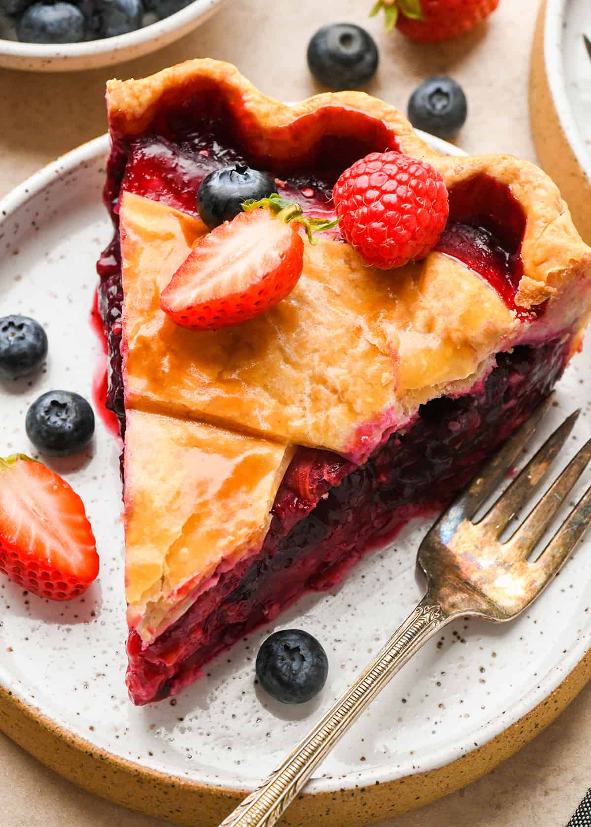 a slice of Mixed Berry Pie on a plate with a fork