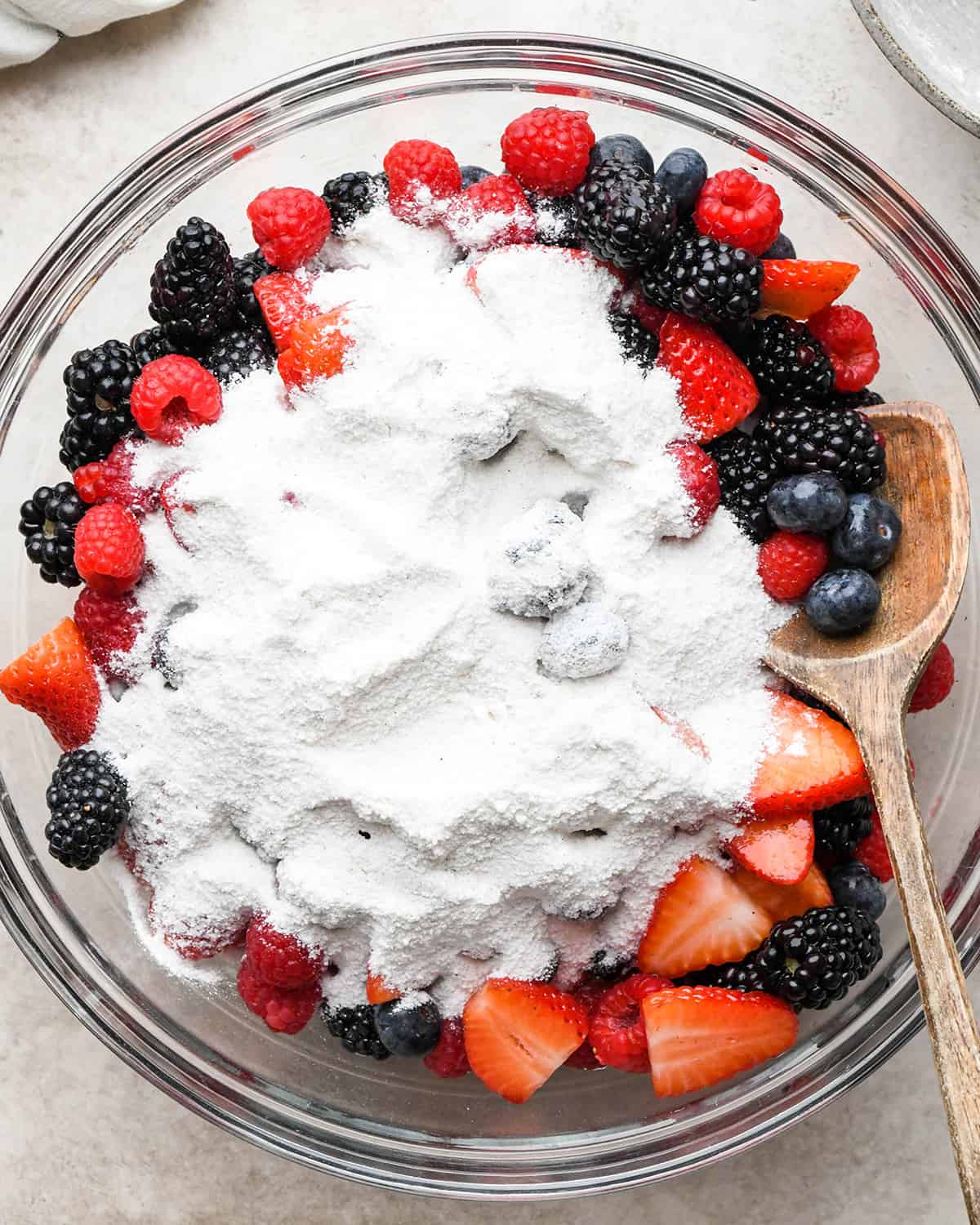 how to make Mixed Berry Pie - dry ingredients poured over berries before mixing