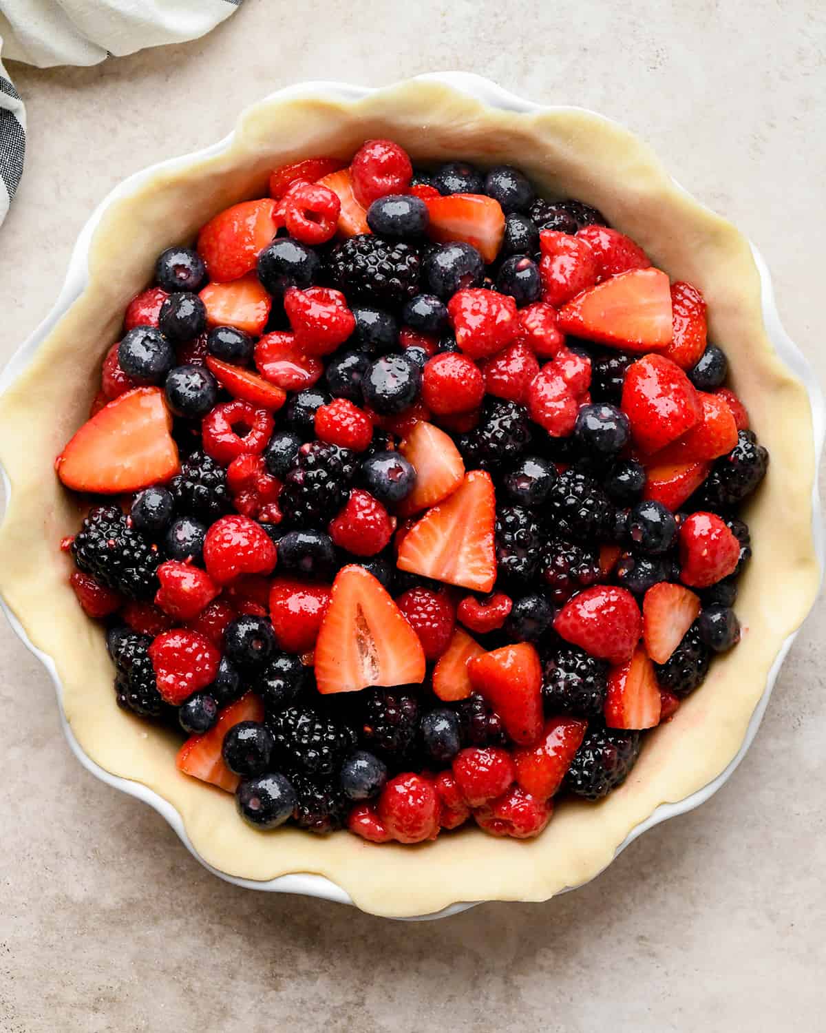 assembling berry pie - filling in bottom pie crust