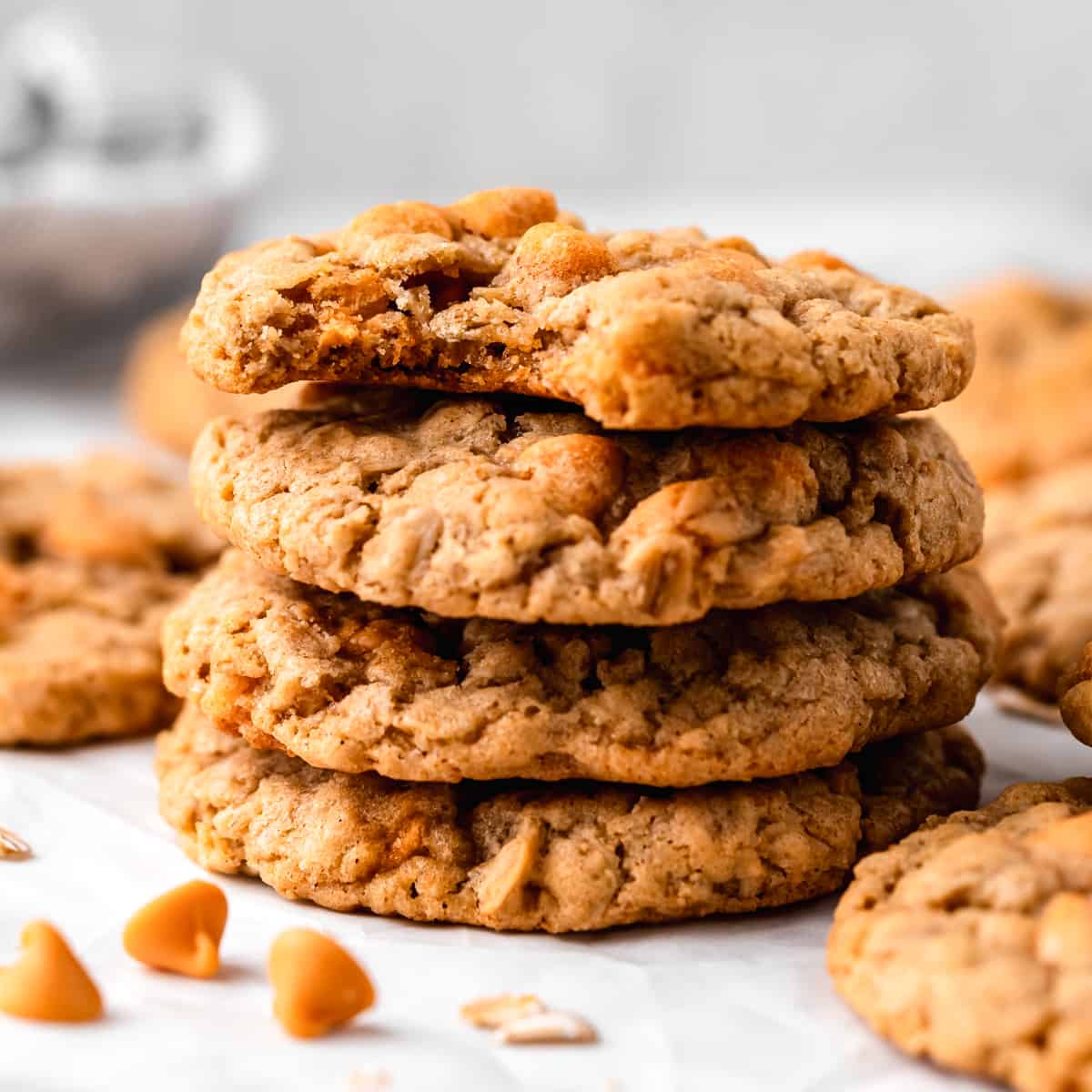 a stack of 4 oatmeal scotchies, the top one has a bite taken out of it