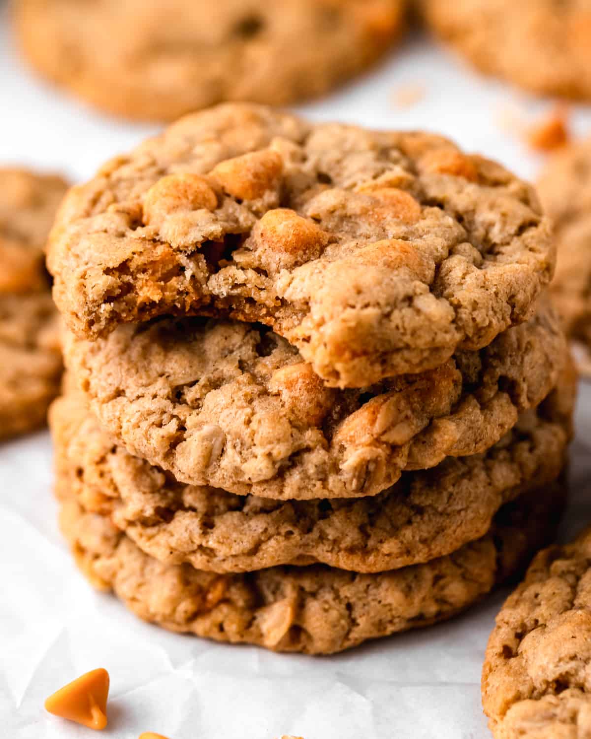 a stack of 4 oatmeal scotchies, the top one has a bite taken out of it