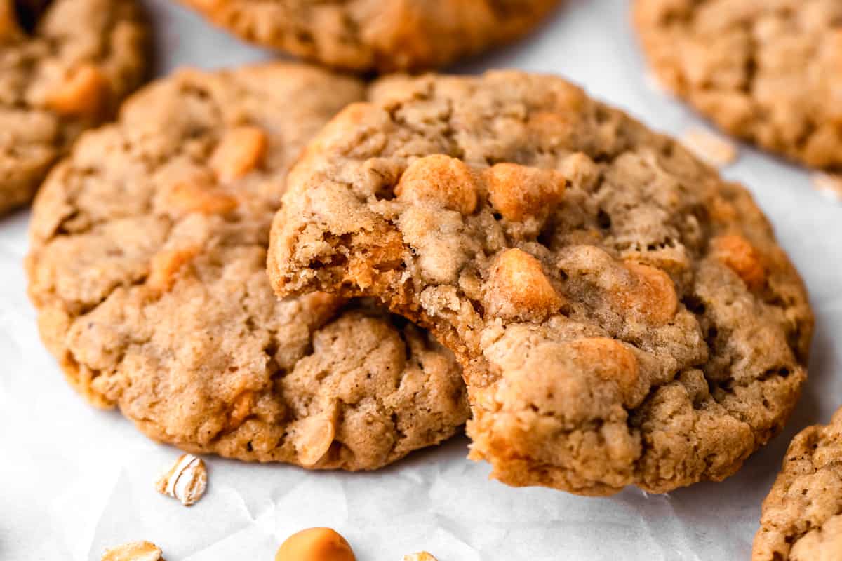 two Oatmeal Butterscotch Cookies, one has a bite taken out of it