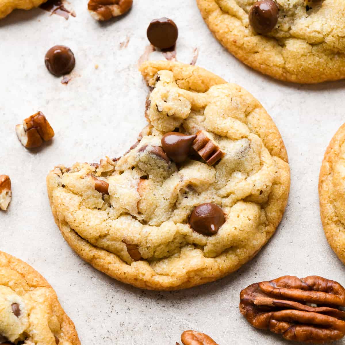 a Chocolate Chip Pecan Cookie with a bite taken out of it