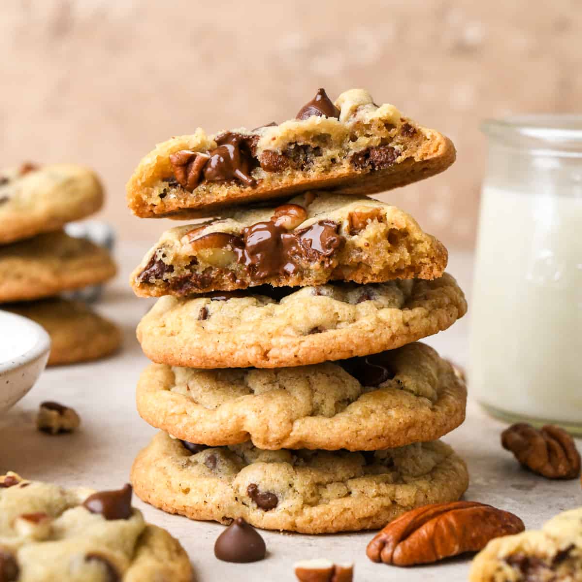 a stack of 4 Chocolate Chip Pecan Cookies, the top one cut in half and stacked so you can see the inside