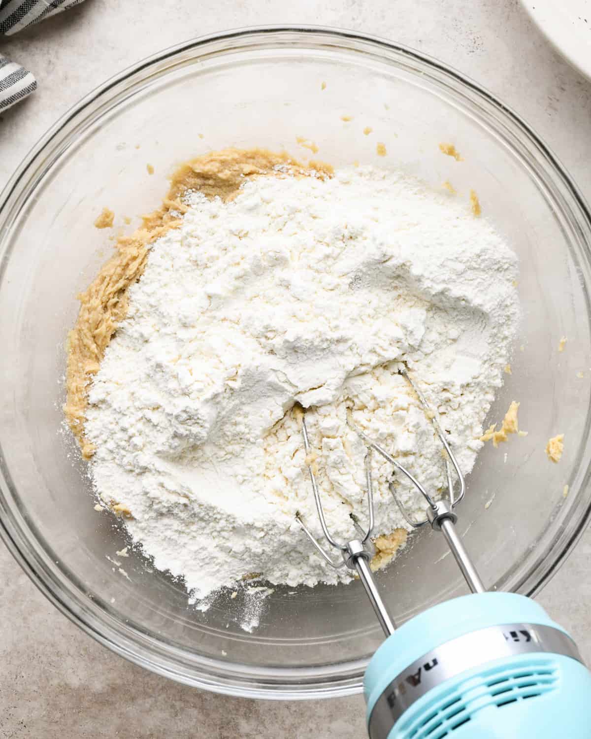 making Chocolate Chip Pecan Cookies - adding dry ingredients to wet ingredients before mixing