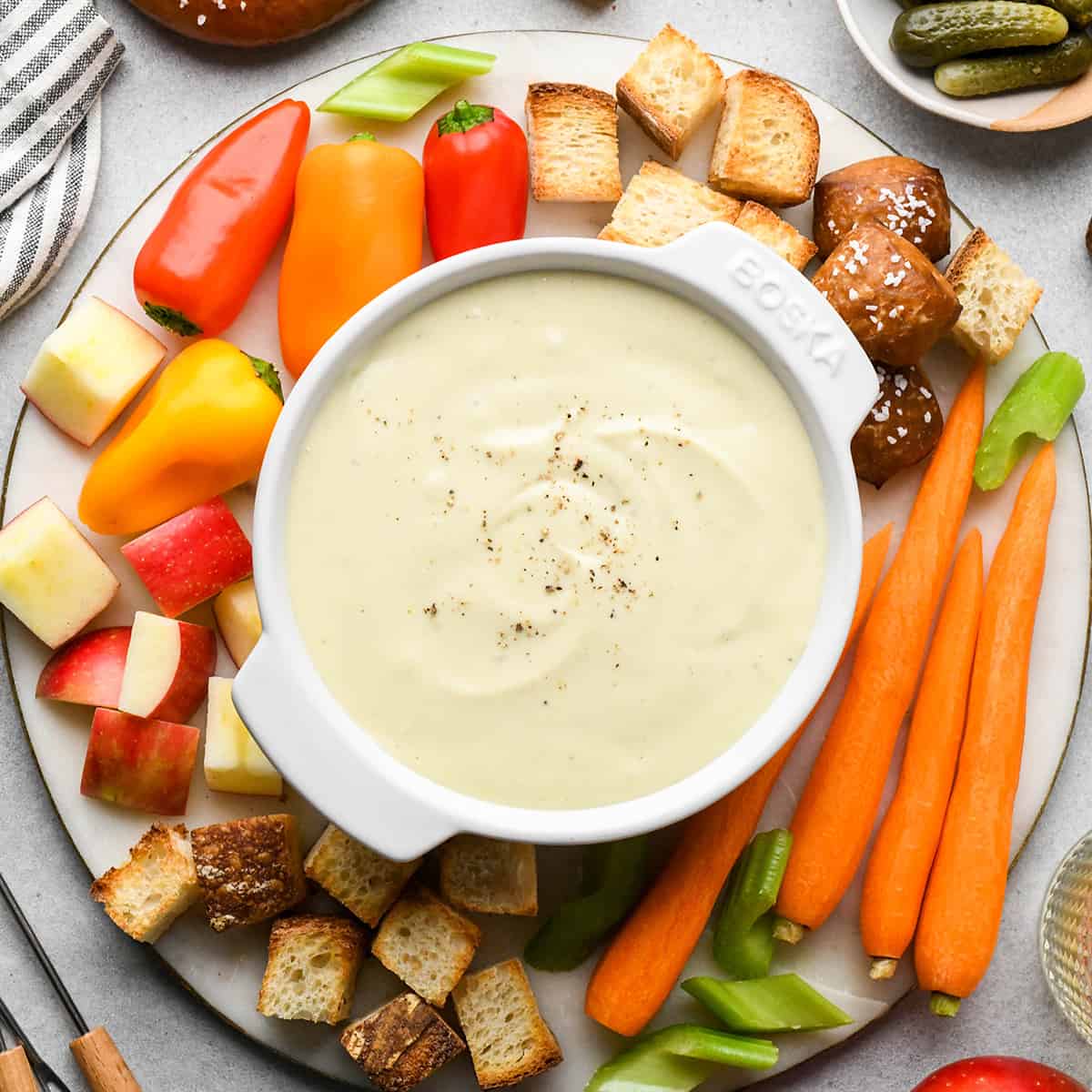 Cheese Fondue in a bowl surrounded by Cheese Fondue dippers