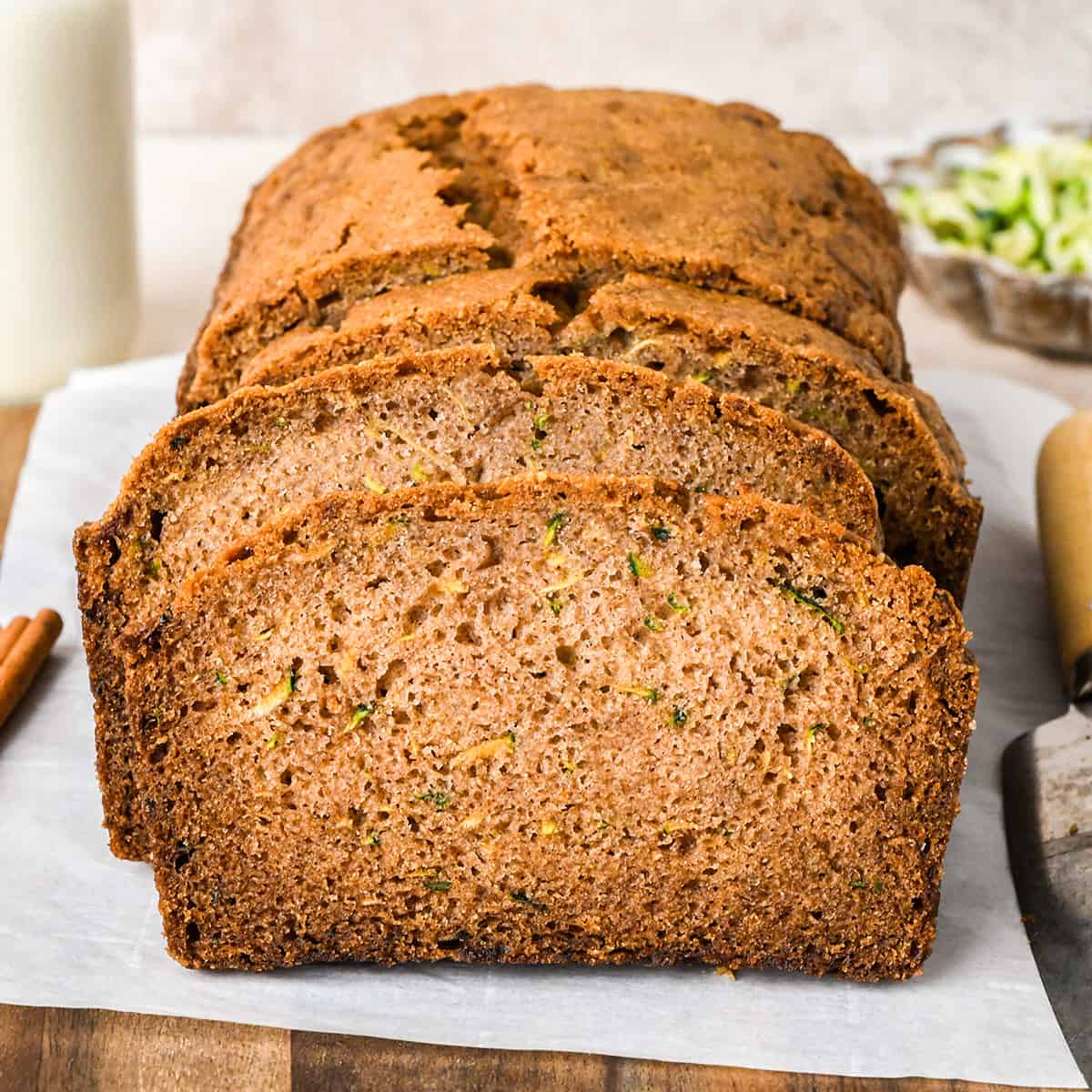 a loaf of Zucchini Bread with 3 slices cut out of it