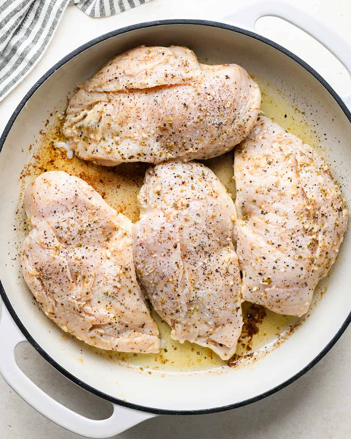 cooking Feta Stuffed Chicken Breasts in a skillet