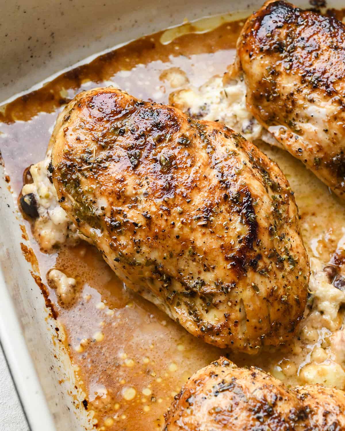 greek stuffed chicken breasts in a baking dish after baking