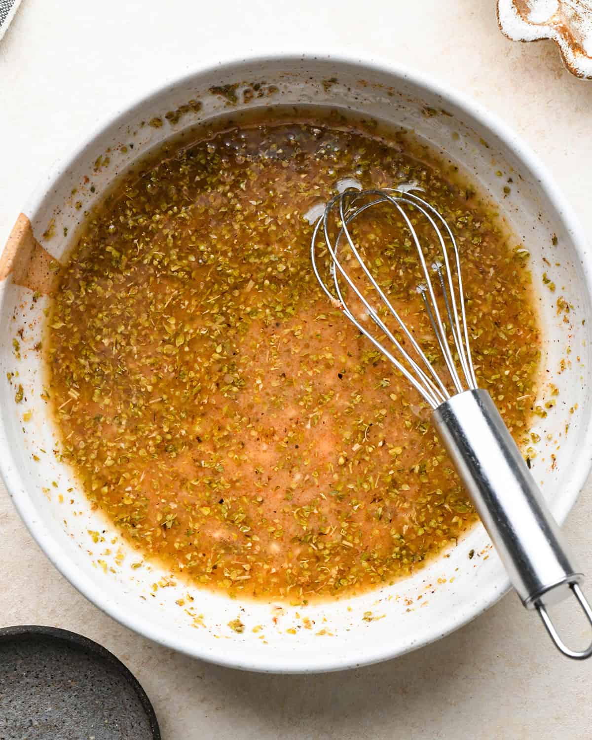 making the greek marinade for Feta Stuffed Chicken Breasts after whisking