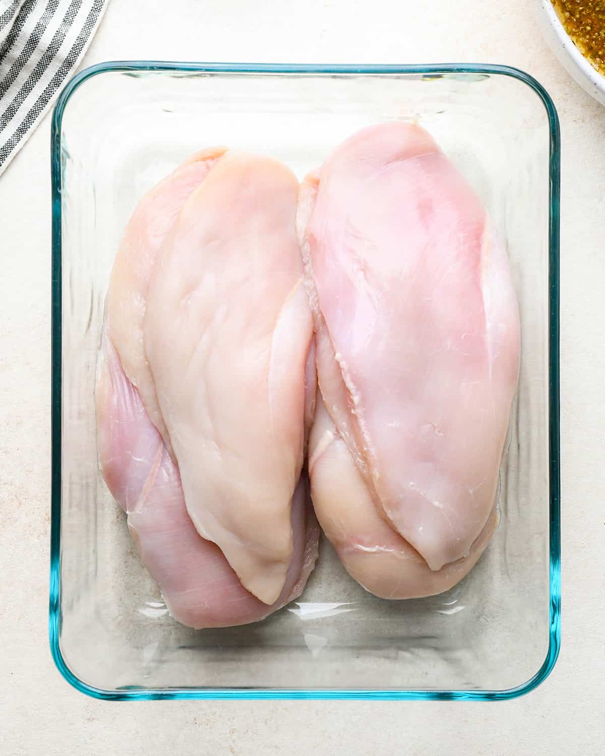 4 chicken breasts in a glass container