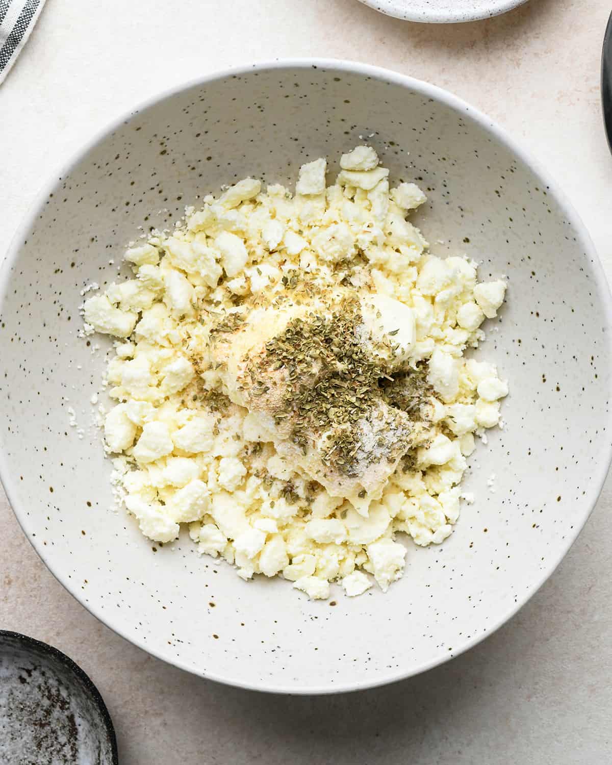 making the filling for Feta Stuffed Chicken Breasts in a bowl before mixing