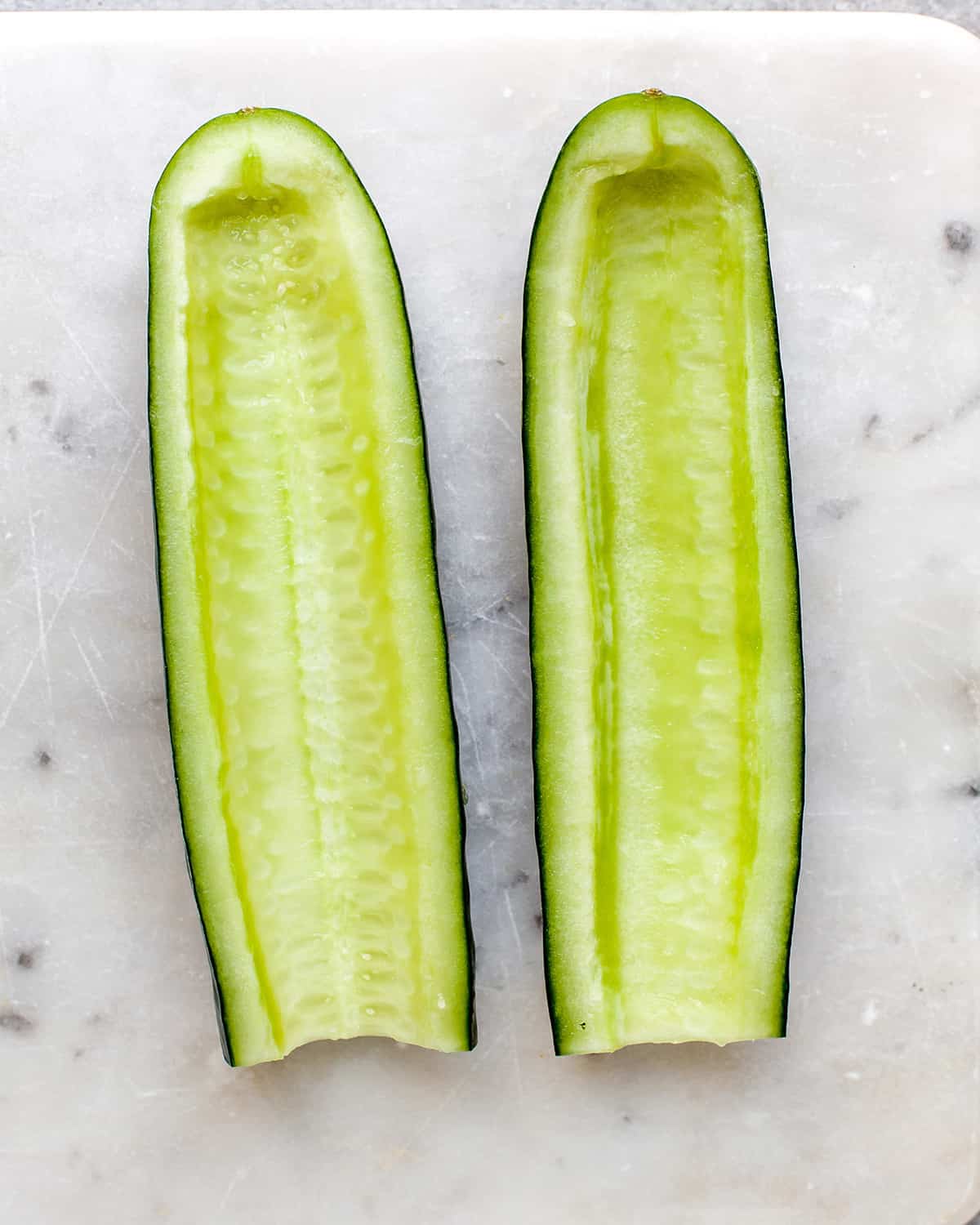 How to Make Tzatziki Sauce - a cucumber cut in half lengthwise and seeded