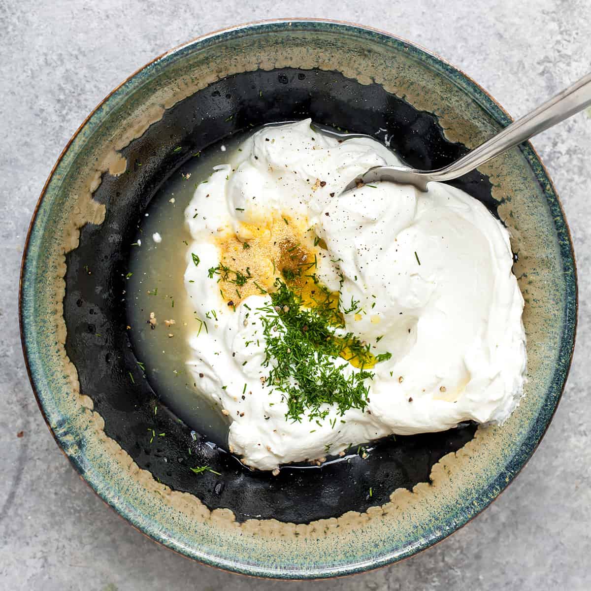 How to Make Tzatziki Sauce - combining ingredients in a bowl before stirring