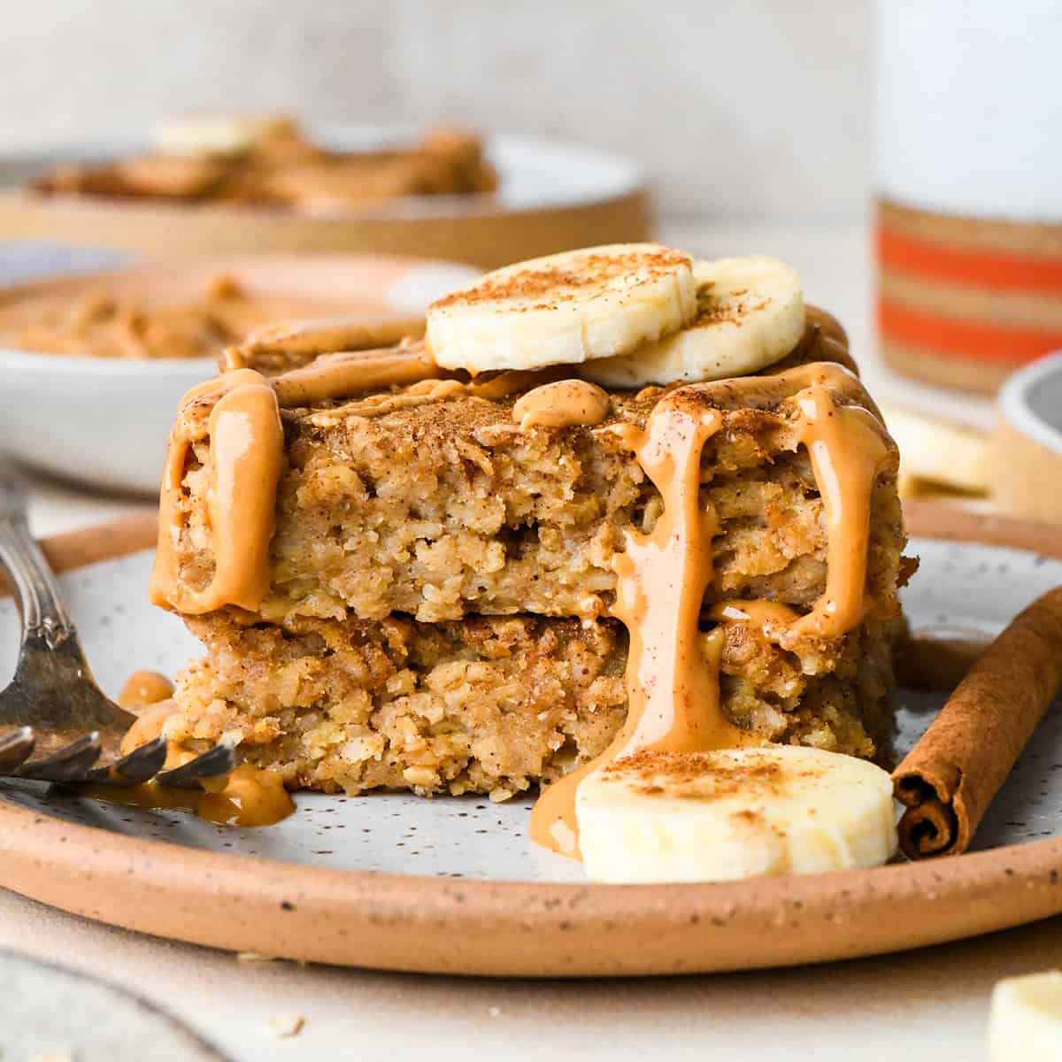 a stack of 2 piece of Peanut Butter Banana Baked Oatmeal with peanut butter and bananas 