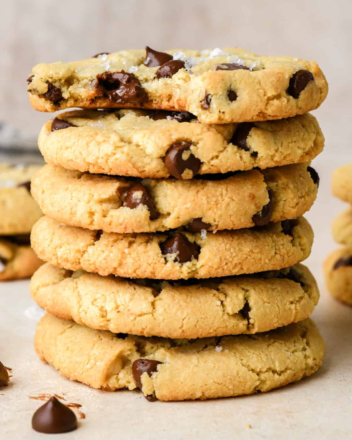 a stack of 6 Almond Flour Chocolate Chip Cookies, the top one with a bite taken out of it