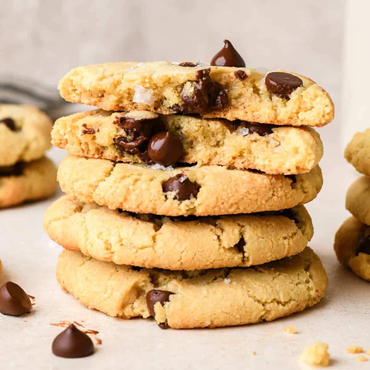 a stack of 4 almond flour cookies, the top one is cut in half so the inside is showing