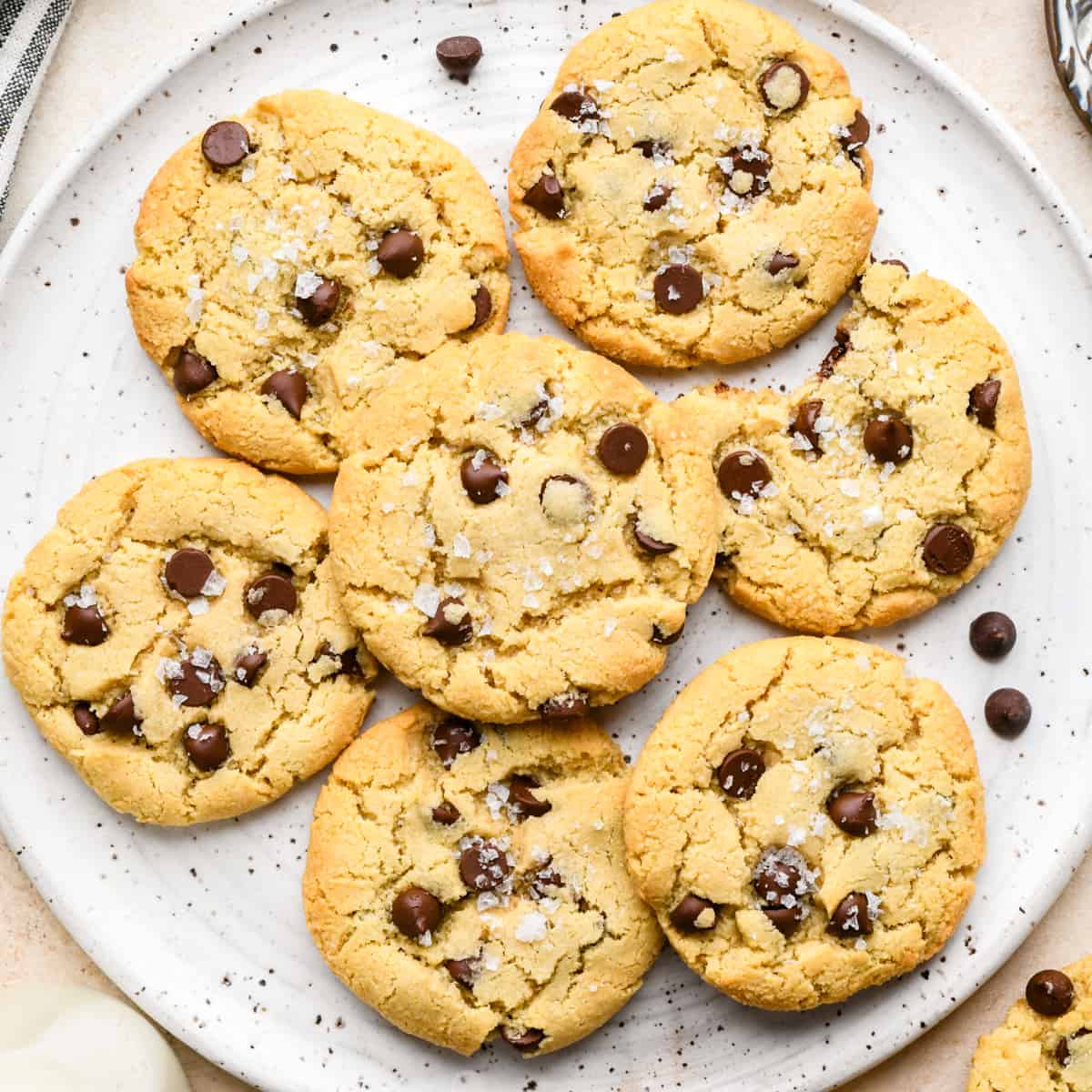 7 Almond Flour Chocolate Chip Cookies on a plate, one with a bite taken out of it