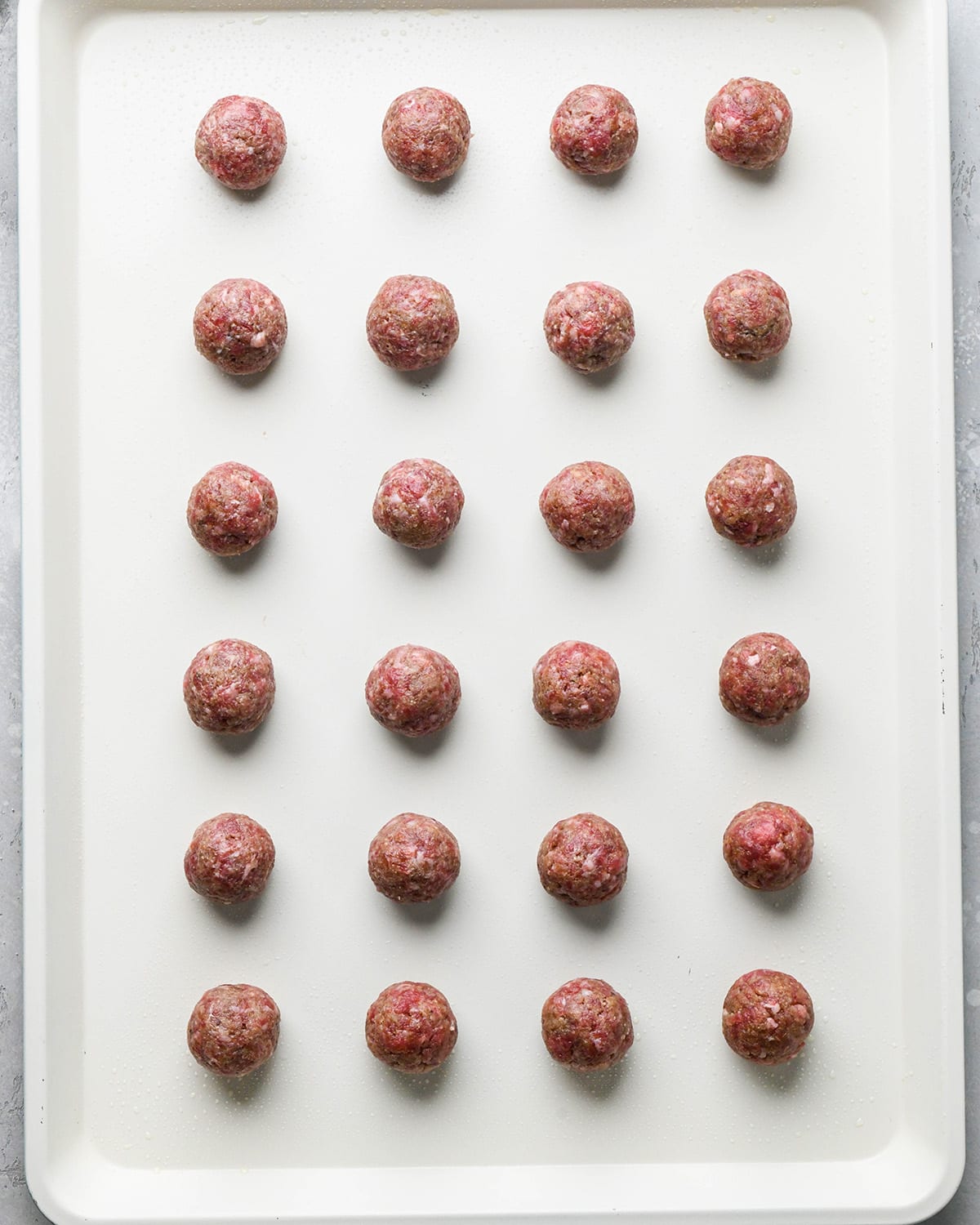 24 Asian Meatballs on a baking pan before baking