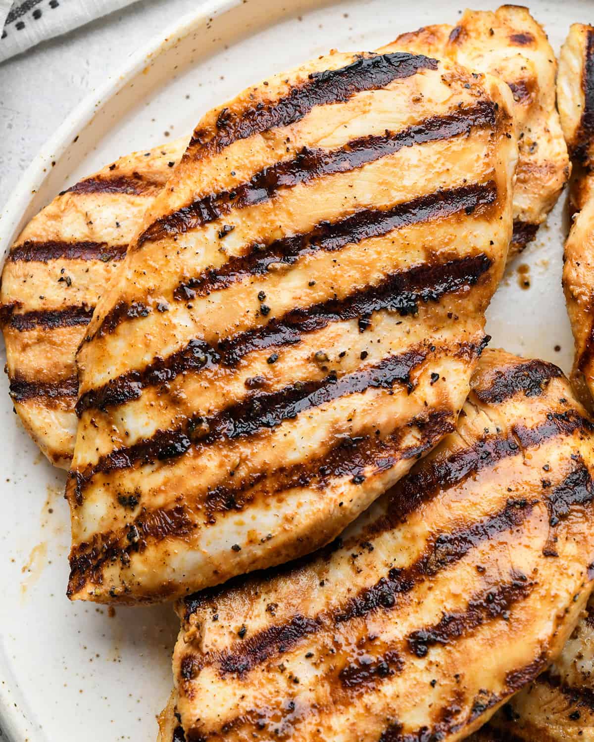 5 grilled Buttermilk Chicken breasts on a plate