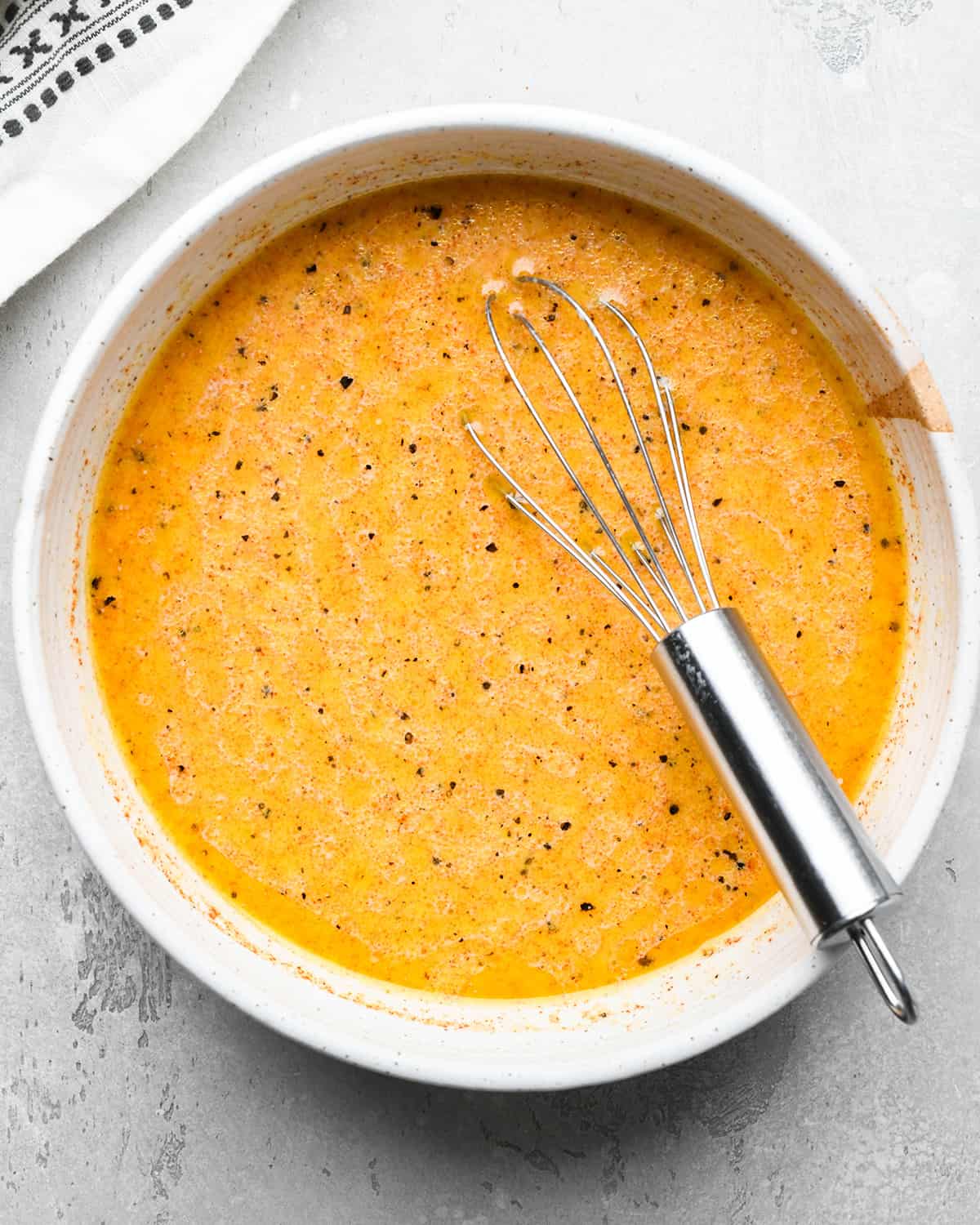 Buttermilk Chicken Marinade ingredients in a bowl before whisking