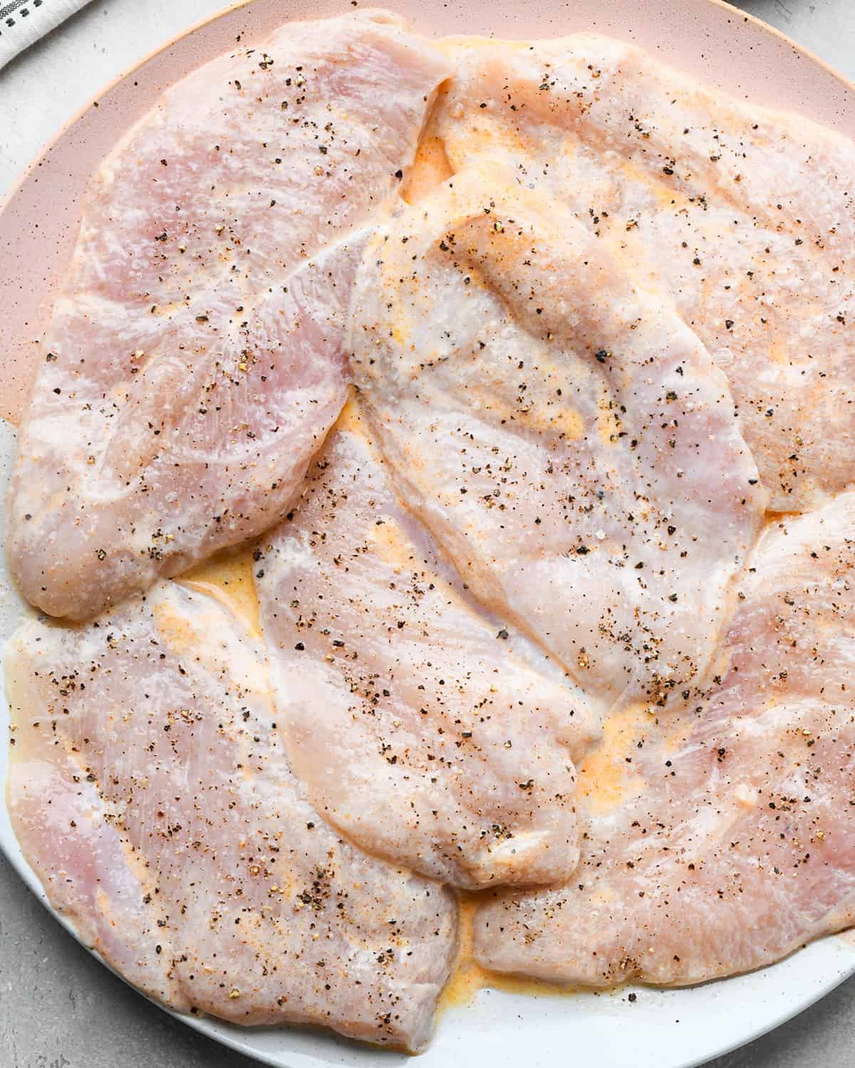 Buttermilk Chicken after it has been marinated and topped with salt and pepper